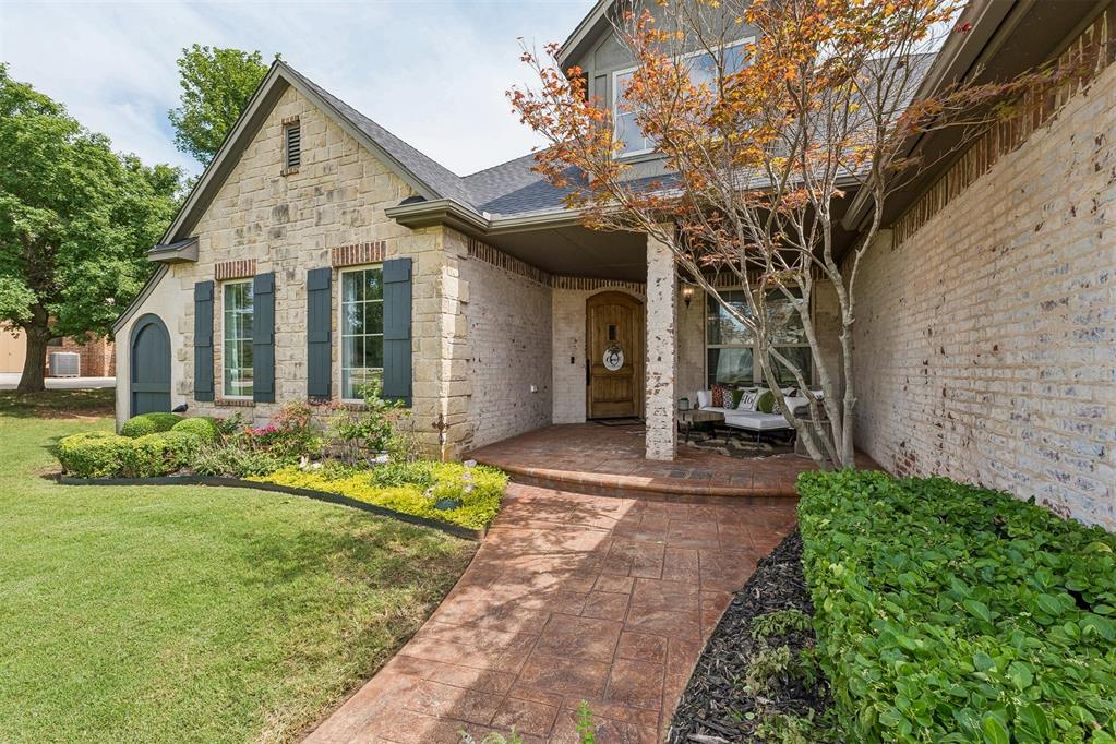 Nestled on an almost half-acre corner lot on the desirable east side of Oak Tree, this beautifully updated European Transitional ranch offers timeless architecture, designer finishes, & exceptional indoor-outdoor living. Located behind Oak Tree’s 24-hour manned gate, this home is just a short walk/golf cart ride to the golf course, clubhouse, & community amenities. As you enter you are welcomed with lighted art niches, crown molding, oversized designer baseboards, rich hand-scraped hardwood floors, & elegant lighting throughout. Every wall, ceiling, door, & trim has been professionally painted. The study features custom built-ins & designer chandelier, while the spacious living room offers a marble-surround fireplace, custom cabinetry, & views of the backyard. The kitchen is designed for entertaining with quartz countertops, Arabesque tile backsplash, Wolf gas range with integrated grill, Bosch dishwasher, center island, breakfast bar, built-in coffee bar & pantry. Custom drapery, Roman shades, updated hardware, & 6 automated shades in the kitchen & dining areas elevate the home’s designer appeal. The functional floor plan includes 4 bedrooms & 3 updated bathrooms on the main level, plus an expansive upstairs bonus room perfect for a media room, game room, fitness space, or guest retreat. The private backyard is an entertainer’s dream with a covered patio, outdoor kitchen, pizza oven, mounted TV, masonry privacy wall, mature landscaping, raised garden beds, & a stunning gunite spool—the perfect combination of an oversized spa & plunge pool with built-in seating. Additional highlights include a 3-car garage with epoxy flooring and storm shelter, circular side drive, automatic sprinkler, modern stair railing, fully renovated spa-inspired primary bath with his and hers separate closets, updated secondary baths with quartz countertops & Zebrino tile, & a 2023 roof. Meticulously maintained and extensively updated, this exceptional Oak Tree home offers luxury & comfort.
