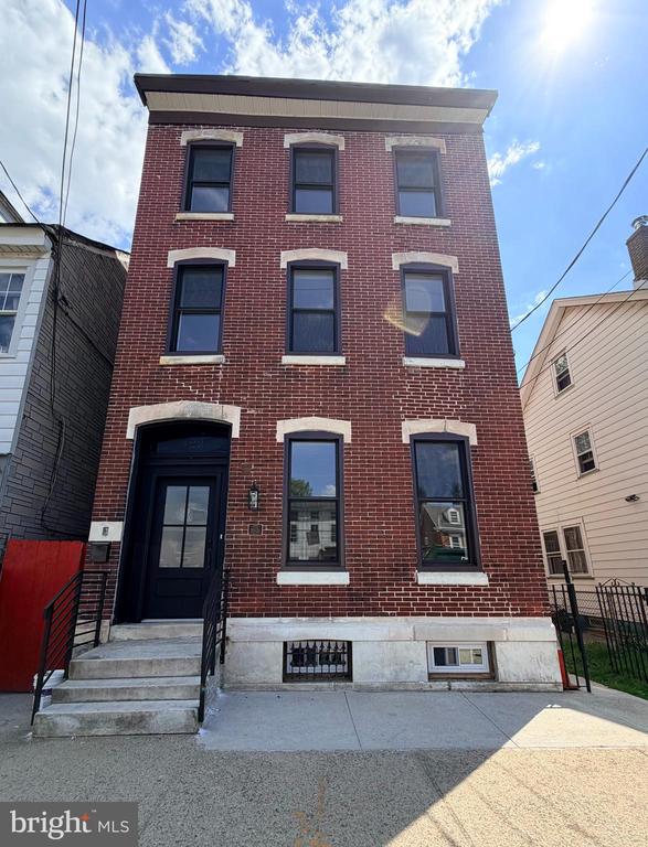 If you’re searching for something truly distinctive, your search ends here! This exceptional historic home blends timeless character with a refined Brooklyn brownstone aesthetic, all set in the heart of Burlington. Completely renovated from top to bottom, every detail has been thoughtfully updated while preserving its unique charm.  Offering six spacious bedrooms, four full bathrooms, and a dedicated office/flex space, this home provides incredible flexibility for modern living. The layout is designed for both comfort and functionality, with generous living spaces and a walk-out basement that adds even more versatility—perfect for entertaining, extended living, or recreation.  Step outside to enjoy the terrace and convenience of private rear parking, a rare find in such a central location. Commuters will appreciate being just steps from the train, making daily travel effortless. Adding to the appeal, the property is also located near Burlington’s upcoming community garden, set to open just behind the home—an exciting addition that enhances the neighborhood’s charm and livability.  With its seamless blend of historic character and modern sophistication, this one-of-a-kind property offers a lifestyle that’s hard to match.