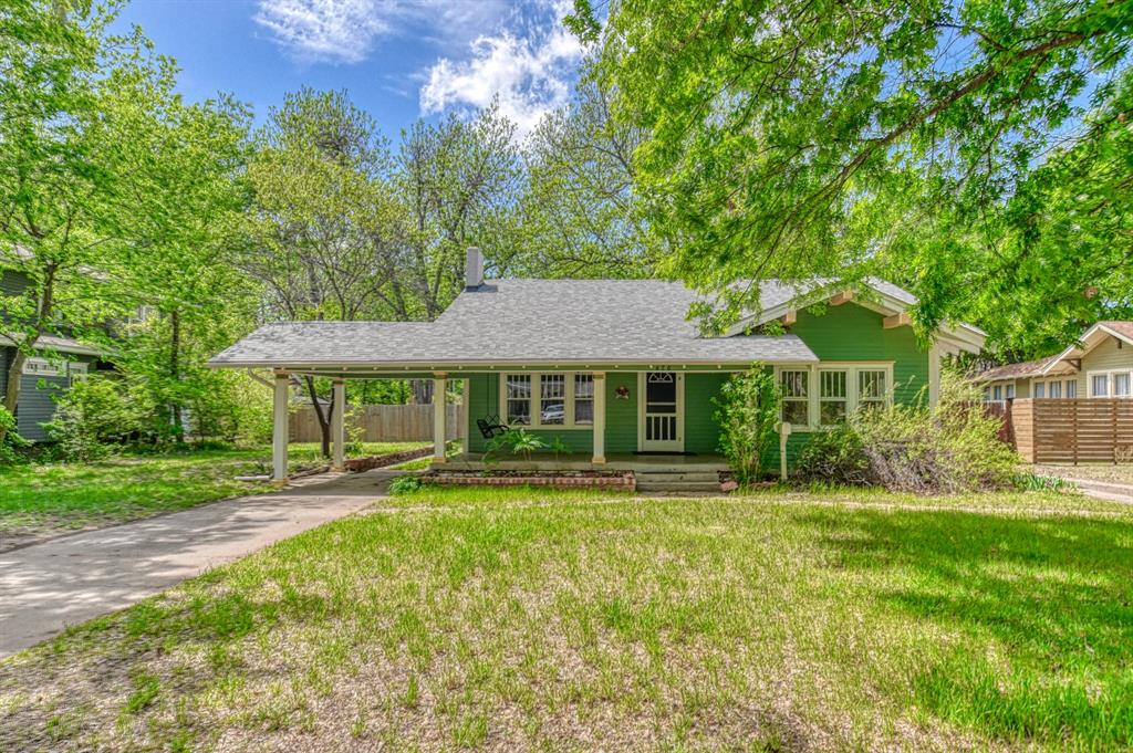 Campus Opportunity knocks with this impeccably maintained 100-year-old home with updated electrical, plumbing, HVAC and water heater on an enormous 1/3-acre treed lot.  Nestled on 3.5 lots with access to a concrete back alley, this space allows room to add more square feet of living space, a detached garage, or even an additional dwelling unit.  The home is surrounded by original oak and pecan trees and lots of parking with two long front driveways. Inside, you are met with 9-foot ceilings and numerous wood framed windows bringing in tons of natural light throughout the entire home! The kitchen is nice and bright, featuring a farm sink with a giant picture window over it, an island, and double ovens! From there, you have an access door to a patio area for easy transfer from grill to table! The usable, dry basement below the home has many possibilities for an additional living space, storage, or safe room! The main living/dining area comes with beautiful wood flooring, ceiling fans, and a vintage fireplace with shelving around it. Enjoy the beautiful weather or even the exciting game day ambience while hanging out on the huge covered front porch! Situated in Chautauqua Historical District, you have a one-minute walk to the Weitzenhoffer Collection at the Fred Jones Art Museum, three-minute walk to Campus Corner, and ten-minute walk to Owen Field. Don't miss your opportunity to grab this campus area gem! Schedule your tour Today!!