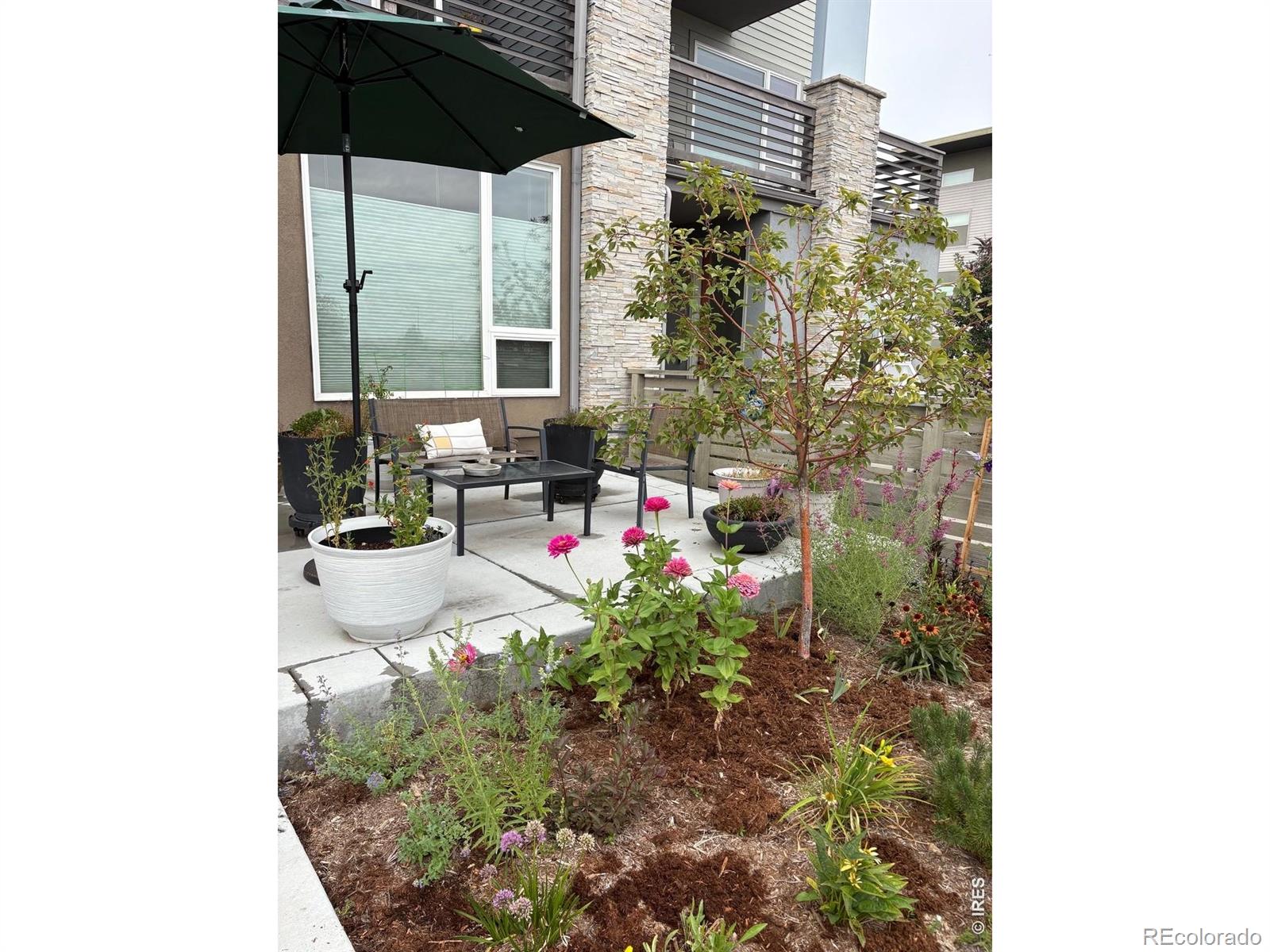 FALL IN LOVE WITH THIS CONTEMPORARY LOUISVILLE TOWNHOME! Walk through a beautifully landscaped courtyard with a peaceful sitting area into this meticulously maintained property that is better than new. The first-floor level provides a spacious, light-filled bedroom or office complete with a private full bath-perfect for guests or remote work. Ascend the stairs to the second floor to find a stunning open floor plan featuring a chef's kitchen with a gas range, high ceilings, artistic pendant lighting, rich wood floors, and a modern, electric fireplace. The third level features two attractive, private bedroom suites, each boasting its own dedicated bathroom and impressive closet space. For ultimate convenience, the laundry area is also located on this floor. Two private balconies provide fantastic outdoor living space, perfect for entertaining or quiet reading and relaxing. Step outside your door directly onto nearby trails, Hecla Lake or stroll just a few blocks to the iconic downtown area. Louisville, Colorado enjoys an enviable reputation for top-rated schools, wonderful restaurants, and a vibrant community. Love your life in Louisville!