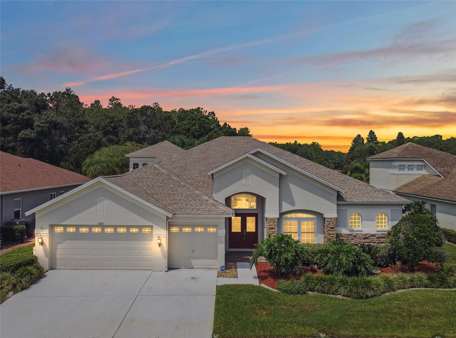 One or more photo(s) has been virtually staged. Welcome to over 3,200 square feet of fully updated elegance in the prestigious, gated Preakness Village of Lexington Oaks Golf and Country Club. This 4-bedroom, 3.5-bathroom home has been thoughtfully redesigned from top to bottom, blending modern luxury with everyday functionality. Step into a grand foyer with soaring 10-foot ceilings and experience the warmth of brand new luxury vinyl plank flooring, paired with soft new carpet in the guest bedrooms. The heart of the home—an expansive open-concept family room with custom built-in shelving—flows seamlessly into the gourmet kitchen featuring new granite countertops, stainless steel appliances, and a motion-sensing faucet. Every detail has been considered, from updated sinks, faucets, and toilets throughout to a brand new AC system just installed for year-round comfort. This spacious floor plan includes a formal living room, formal dining room, a dedicated office, and a versatile upstairs bonus room with a remodeled half bath—perfect for a home gym, theater, or playroom. Enjoy peace of mind with hurricane-impact windows and sliders (a $30,000 value), a 2021 roof, and a finished garage with epoxied flooring and Wi-Fi-enabled MyQ garage door opener. A water softener and reverse osmosis system ensure top-tier water quality throughout the home. Step outside to your extended screened-in patio (electric set up for a Spa), surrounded by mature palm trees and lush landscaping, with a tranquil pond and conservation view near the 18th hole—an entertainer’s paradise or your private retreat. With over $100,000 in recent upgrades, this move-in-ready home stands out as one of the best values in the community. Residents enjoy resort-style amenities including a clubhouse, pool, fitness center, tennis and basketball courts, sand volleyball, and scenic walking/biking trails. Conveniently located just minutes from I-75/I-275, Wiregrass Mall, Tampa Premium Outlets, and top-rated schools. Don’t let this rare opportunity pass you by—schedule your private showing today!