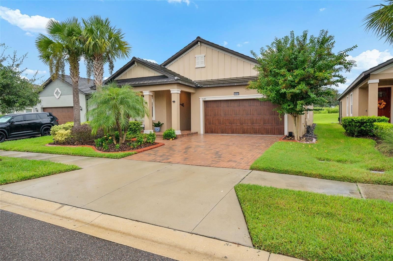 WOW! We are pleased to present this gorgeous home for sale with so many extras and upgrades and priced for quick sale. If you are seeking the upscale Mirada lifestyle and want to be in a 55+ age-restricted area, schedule your tour right away. This home is on a premium lot with no rear neighbors, overlooking nature. Plus, the owner has enclosed (screened in) the back patio  for your bug-free hang-out, which includes a door to the backyard plus doggy door, ceiling fans and pull-down shades that you can see out but not from the outside in. The lot size extends 225 feet on one side and 152' on the other side (survey available). The front of the home is professionally landscaped, which you can enjoy from the front shady covered porch.  Irrigation system keeps plants green and lush. Pest control and Termite protection system is kept up to date.  This home is a true 3 bedroom (flex room was modified with addition of a built-in closet and doors). There are 2 bathrooms and a 2-car garage. Custom front door with etched glass. Gorgeous ceramic tile flooring throughout, a builder upgrade. Kitchen pantry has been upgraded with custom sturdy wood shelving. The counter tops are an upgraded quartz. Dishwasher is brand new. Designer tile backsplash. Crown moulding throughout. Owner has added a closet and cabinets in the laundry room, plus a custom counter in the 3rd bedroom (currently used as an office). The hot water heater is a hybrid model that provide cooling to the garage. The attic was improved with a floor and pull-down ladder.  Upgraded addition to HVAC (2026) was installed: an advanced UV germicidal light system for optimal indoor air quality and continuous mold prevention. Washer Dryer included in sale.  And a BONUS! Buy now and seller will include a golf cart (with extra seating to take your guests or family members to the Lagoon)... there are golf cart pathways and parking throughout Mirada. Golf cart has been cared for and recently serviced . No Flood zone! The community amenities are unbelievable - Located in the premier gated 55+ section of the neighborhood, residents enjoy exclusive access to the private Medley clubhouse, featuring a resort-style heated pool, a fitness center, a bar and grill, and dedicated tennis, bocce, and pickleball courts. Homeowners also get full entry to the spectacular 15-acre Mirada MetroLagoon® by Crystal Lagoons, the largest of its kind in Florida, complete with pristine beach areas for swimming, kayaking, and paddleboarding. The community further enhances its resort lifestyle with miles of scenic walking trails, golf cart-friendly paths, and dedicated pet perks including a dog park and washing station. HOA and community related fees average approximately $522.60 / month, which includes Mirada Master Association ($271.09 quarterly), Lagoon Access ($130.07 quarterly), Medley HOA ($234.90 monthly), and Medley Amenities ($153.98 monthly), providing access to the private Medley clubhouse amenities along with the year round Mirada Lagoon. Note: Culligan water system and refrigerator are excluded from this sale. Be fast to schedule your home tour and bring your best offer before someone else does!