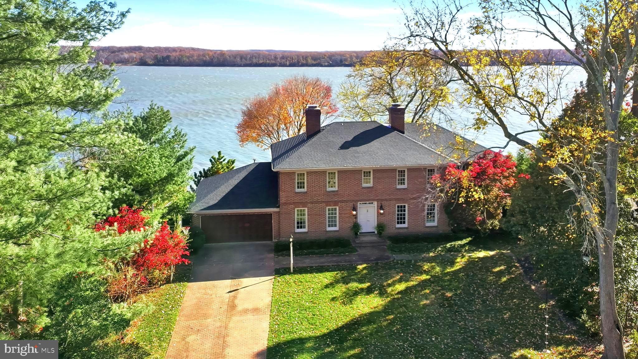 Incredible opportunity to share the same views as George Washington's Mount Vernon Estate! The home, which replicates the front exterior of Colonial Williamsburg's George Wythe House, transforms to a bright, glass walled rear exterior that capitalizes on its truly stunning panoramic Potomac River views. This unique property offers a blend of historic charm, recent major improvements, and maritime lifestyle that make it a truly one-of-a-kind property. Over the past few years, the owner has spent seven figures on improvements including but not limited to: deVOL Kitchen and butler's pantry, a primary bath/closet addition by Case Design, extensive dock work including covered boat lift, covered sitting area, floating dock, and two jet ski lifts. Over 2,200 square foot travertine terrace capitalizes on the 180 degree elevated Potomac River views and benefits from conservation easement across the River which requires the same view George Washington enjoyed 250 years ago. Situated on nearly 1 acre grounds just 8 miles from Old Town Alexandria and 20 miles from Washington DC provides a private sanctuary to vacation at home every day.