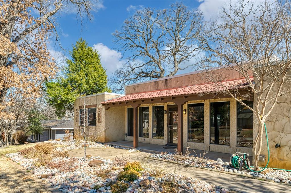 Nestled in the heart of Bedford, this meticulously maintained and thoughtfully updated Spanish-Mediterranean style home seamlessly blends timeless architectural charm with modern elegance. Recent updates include fresh interior paint throughout, brand-new carpeting, all new blinds, and beautifully updated light fixtures, creating a bright, cohesive, and truly move in ready space. The spacious layout features an oversized living area with beautiful wooden floors, large picture windows, and a seamlessly integrated built-in office space, perfect for working from home, a study, or a second living area. The light-filled formal dining space flows effortlessly into the updated eat-in kitchen, complete with a beautiful tile backsplash and warm wooden cabinetry ideal for both casual dining and entertaining. Each bedroom offers generous space and privacy, complemented by two well-appointed bathrooms. Enjoy outdoor living with a tree-shaded backyard and a fully enclosed sunroom that functions as a true extension of the home perfect as an additional living area, playroom, or flex space. Ideally located near top-rated schools, shopping, dining, and major highways, this home offers the perfect balance of beauty, comfort, and convenience.