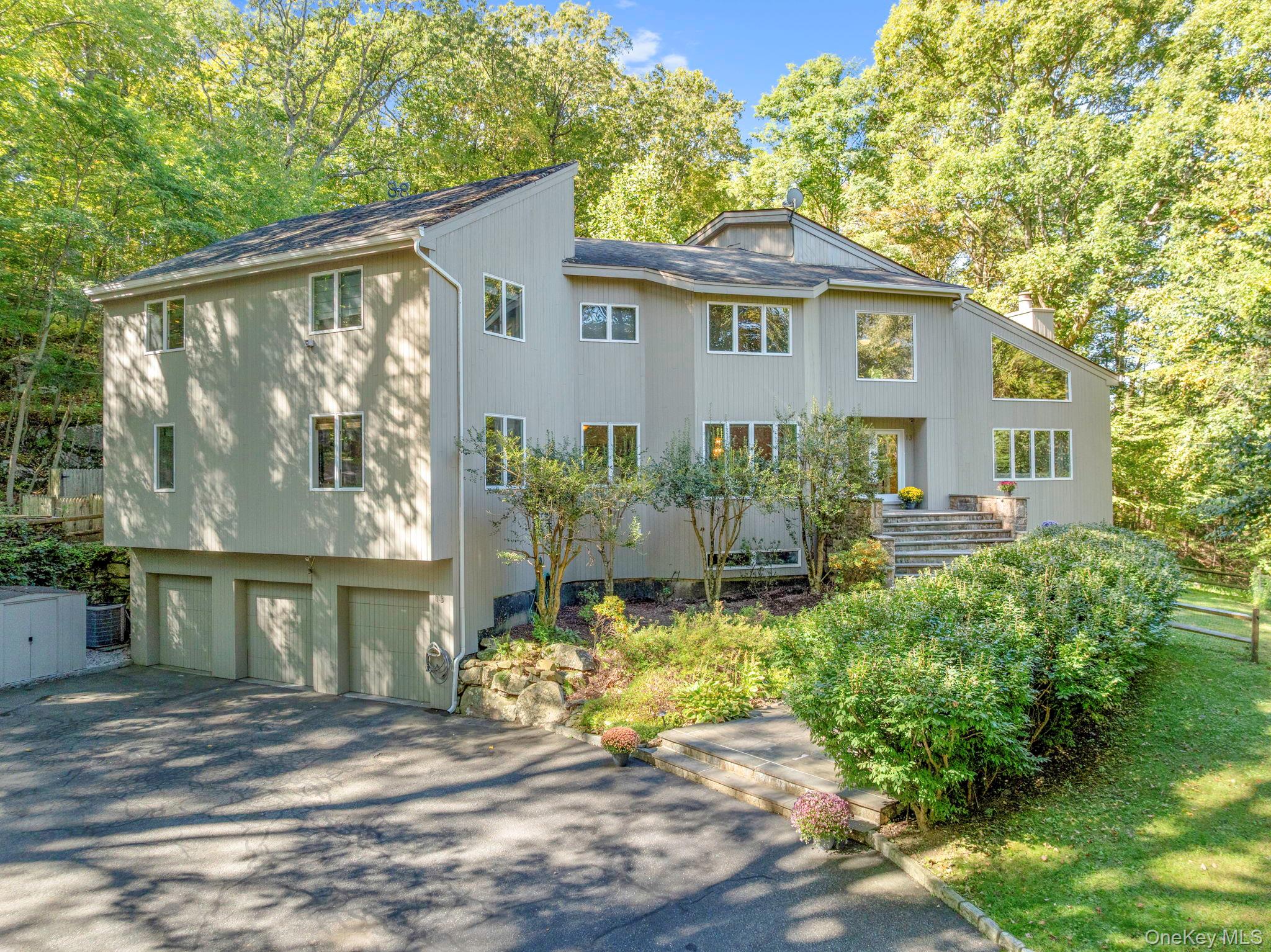 Move right into this bright and spacious 4 bedroom/5.1 bath contemporary home with Byram Hills schools, privately set on 3.41 acres in a quiet cul-de-sac.  Dramatic foyer with 20'+ ceiling height and very generously sized rooms throughout.   Flexible layout lives like a five bedroom including a main-level guest suite, ideal for a home office or au pair, along with an eat-in kitchen and pantry, dining room, family room and living room both with fireplaces, and a fabulous three season sunroom with deck access.  Upstairs features an oversized primary suite with deck,  very large walk-in closet, and spa bath, plus one en-suite bedroom with bath and two additional bedrooms share a hall bath. The finished lower level offers an expansive recreation room with movie screen and projector, sliding glass doors to yard, separate gym, full bathroom, office, and garage access.  Special features include two decks, cathedral ceilings, full house generator, many built-ins, skylights,  3-car garage, fenced-in yard and tons of storage. Easy commute to NYC with many 38 minute Metro North Express trains from North White Plains with plenty of parking available. All Byram Hills schools are located in Armonk. Some benefits of Byram Hills school district: School busing for all. Armonk Children’s Corner offers before and after school care for children in grades K-6th. School Activity bus takes kids to many after school activities around town. Fabulous Town of North Castle Recreation Department offers many sports, activities, camps, parks and Armonk Town Pool. Taxes include trash pick up at curb, but can pay extra for garage door pickup. Near Armonk, Bedford Village & Greenwich.