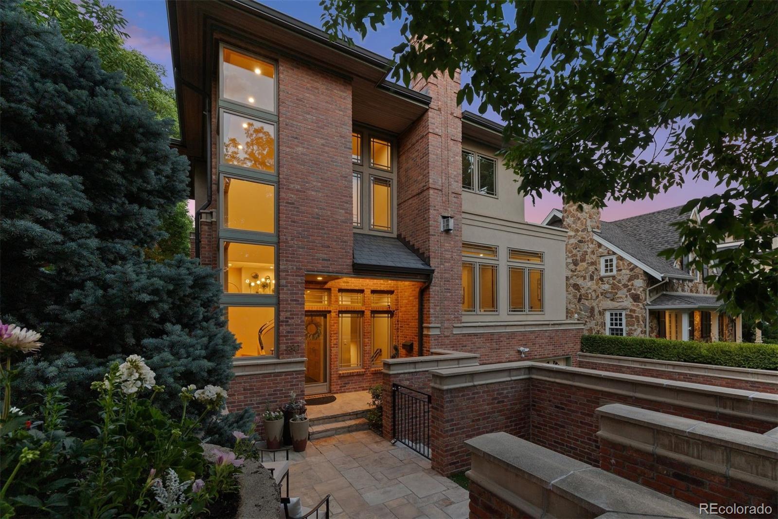Perfectly positioned on a prized corner lot in the heart of Cherry Creek North, this Frank Lloyd Wright-inspired townhome marries the best of form and function with expansive rooms, corner floor-to-ceiling windows, and private outdoor spaces.A dramatic two-story glass entry creates an unforgettable first impression, leading into light-filled living spaces. Bamboo floors flow throughout the main level, where gathering areas include a warm and inviting living room with a fireplace, a dining room with a Juliet balcony, a dedicated reading nook/office with wine fridge, and a chef’s kitchen appointed with custom SieMatic cabinetry, granite countertops, Viking and Sub-Zero appliances, a Bosch dishwasher, and an eat-in breakfast nook.The upper level offers a private retreat anchored by a spacious primary suite with a remodeled five-piece bath, fresh paint, and an oversized custom walk-in closet. A second en-suite bedroom with fresh paint completes the second floor.Designed with flexibility in mind, the lower level features a generous family room, a third en-suite bedroom, wine cellar, extensive storage, and glass sliders that open onto a secluded courtyard patio.The three private outdoor spaces, including two patios and one balcony, create intimate settings for relaxing and entertaining. Exceptional mechanical upgrades include in-floor radiant heat throughout, high velocity AC, and a new state-of-the-art boiler system with radiant heat floors for efficient year-round comfort. An attached heated two-car garage and heated driveway add a level of convenience rarely found in urban living. A new roof installed in 2024 is an added bonus!Offering architectural distinction and an unrivaled Cherry Creek North location, this remarkable residence presents a rare opportunity to enjoy luxury living at its finest.
