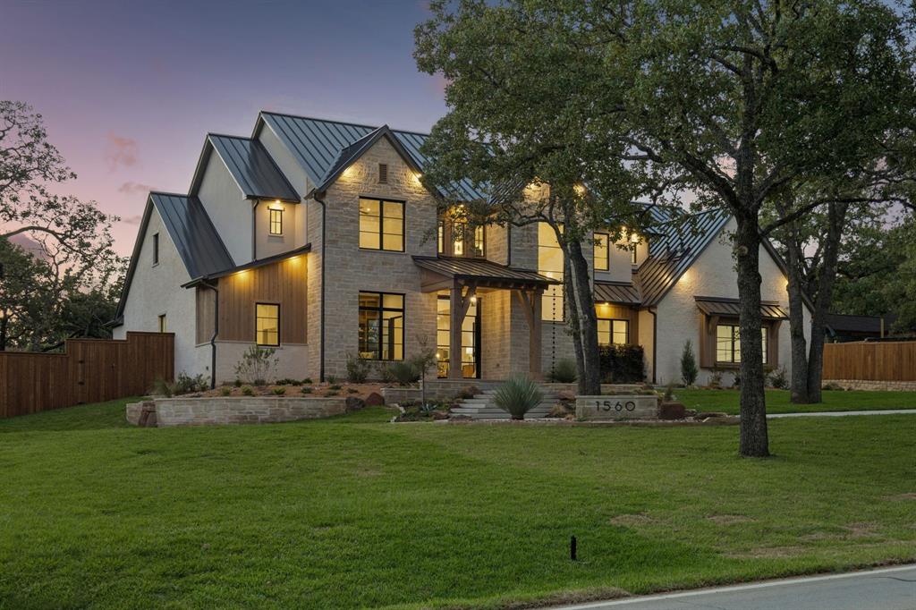 Welcome to luxury nestled on nearly an acre with lots of mature trees in the heart of Keller. This custom home combines architectural design with the quiet, expansive feel of a country estate while remaining just minutes from city conveniences. Designed for seamless indoor-outdoor living, the open-concept floor plan showcases soaring ceilings, oversized windows that flood the home with natural light, and high-end designer finishes throughout. The grand living room features a massive 16x10 pocket sliding glass door that disappears into the wall, completely blending the interior comforts with the pristine nature outside. The adjacent gourmet kitchen is a chef's dream, anchoring the main living space with statement lighting, custom cabinetry, and a Thermador appliance package. Tucked just behind the main cooking area is the ultimate dream prep kitchen, engineered perfectly for meal prep, hosting large gatherings, or keeping the main kitchen entirely clutter-free. This high-end secondary workspace comes fully loaded with a second full-size refrig, an additional dishwasher, dual built-in ovens, warming drawer, microwave and surrounded by ample extra counter space. Steps away, an oversized walk-in storage closet provides the ideal layout, explicitly designed to handle large-scale Costco stock-ups and bulk grocery trips. The dedicated first floor media-gameroom space features wet bar for effortless hosting and its own set of sliding doors that open directly to the backyard, creating a perfect flow for indoor-outdoor parties. The private primary bedroom offers a true sanctuary with spa-inspired primary bath—complete with soaking tub and walk-in shower. The walk-in closets tailored for optimal organization, highlighting a built-in vanity in her closet and a dedicated washer-dryer directly inside his closet. Also located on the 1st floor is a highly desirable secondary bedroom that is exceptionally spacious, offering the size, comfort, and privacy of a second primary bedroom.