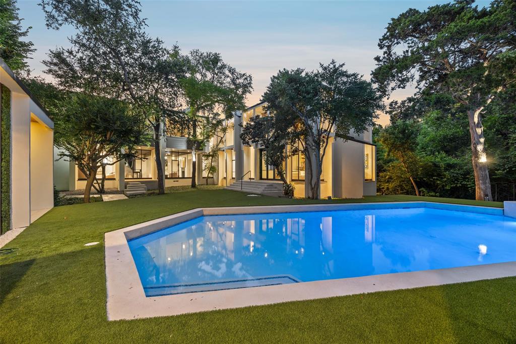This stunning modern residence is a rare opportunity to own a home crafted by two of the most respected names in architecture—Downing Thomas and Bill Booziotis. Set on a tranquil creek lot at the end of a quiet cul-de-sac, this 7,955-square-foot architectural gem exemplifies timeless design and seamless indoor-outdoor living.

Expansive windows flood the interior with natural light, while clean lines and thoughtfully curated finishes define the home’s modern sophistication. The open-concept living areas are complemented by soaring ceilings and a seamless flow that’s perfect for both elegant entertaining and everyday living.

The home features a spacious media room, ideal for cinematic experiences, and a luxurious outdoor oasis complete with a fully equipped kitchen—perfect for al fresco dining, lounging, and year-round gatherings.

Offering privacy, beauty, and architectural significance, this residence is more than a home—it’s a work of art in one of the most desirable settings available.