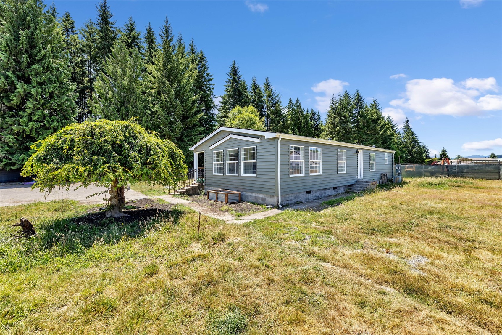 Make yourself at home in this 1,512 sq ft double-wide manufactured home in Toledo, WA, set on a vast, usable 5 acre flat lot. Relish a breathtaking view of Mt. Rainier from your doorstep and enjoy modern enhancements, including a newer roof, fresh siding, and updated flooring. With 3 bedrooms, 2 bathrooms, and convenient freeway proximity, this well-maintained property balances tranquility and accessibility. Space for an RV or Trailer AND with hookups! Ideal for those seeking a slice of countryside living.