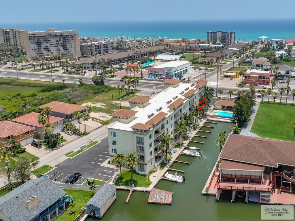 Coastal Channel-Front Retreat- Beautifully decorated and fully furnished, this 2 bedroom, 2 bath coastal condo offers stunning channel-front views and relaxed island living.  Enjoy a spacious open-concept layout with a spacious kitchen boasting stainless steel appliances, a massive granite  island with bar seating, a walk-in pantry, and seamless flow into the living and dining areas.  A versatile bonus room provides space for a TV lounge, home office, or additional guest accommodations.   Enjoy the convenience of two private balconies perfect for your morning coffee or evening cocktails and a deeded boat slip for direct water access.  Whether you are boating, relaxing, or entertaining, this turnkey condo is the perfect waterfront escape. Las Marinas offers.. A deeded boat slip, infinity pool w/waterfall, shaded poolside cabana, fishing deck, plenty of parking with channel/Bay frontage. A Common Elevator makes bringing up groceries, beach gear, and luggage a breeze. $5000.00 credit.