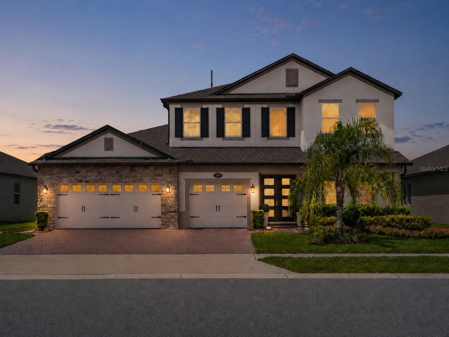 Virtually Staged. Built in 2022 and UPGRADED from top to bottom, this stunning Tradewinds model M/I Home is a 4-bedroom, 3.5-bath POOL HOME in the gated Red Ember North community, that delivers the look and feel of a model home with an exceptional Oviedo location! The RESORT STYLE POOL and SCREEN ENCLOSURE were added in 2023 – complete with solar heat, fountains, fire features, an extended paver patio, wired tiki torches and lush privacy landscaping. Inside, elevated builder finishes and thoughtful owner updates continue throughout, including WOOD LOOK PLANK TILE FLOORING, upgraded cabinetry and countertops, 8’ interior doors, crown molding, designer lighting and statement accent walls. Natural light fills the spacious OPEN CONCEPT main floor, where oversized living and entertaining spaces flow effortlessly together. The family room makes an impression with a STACKED STONE FEATURE WALL and BUILT-IN ELECTRIC FIREPLACE, while the dining room features a magazine worthy coffered ceiling. The kitchen is equally polished with upgraded cabinetry, sleek countertops, pendant lighting and a backsplash extended to the ceiling. Glass French doors open to a DEDICATED OFFICE (or flex space!), while a MEDIA ROOM and additional versatile spaces provide plenty of room to work, relax or entertain. The generous MAIN FLOOR PRIMARY SUITE is complemented by a spa-inspired en-suite bath featuring tiled walls, a FREESTANDING SOAKING TUB and SEAMLESS GLASS ENCLOSED WALK-IN SHOWER. Upstairs, slatted accent panels add custom style to the loft and media spaces. With 4 bedrooms PLUS an office and media room, 3.5 baths and a 3-car garage, this floor plan offers exceptional flexibility without sacrificing its open, airy feel. Outside, an oasis awaits designed for year-round Florida living. The fully screened, SOLAR HEATED POOL, fountains, FIRE FEATURES, extended sealed pavers, UPGRADED LANDSCAPING, bamboo privacy screening and outdoor lighting create a private resort-style retreat. Enhanced landscaping, DECORATIVE GLASS FRONT DOORS and sealed pavers add standout CURB APPEAL to the front as well. Located in Red Ember North of sought-after Oviedo, this GATED COMMUNITY is ZONED FOR TOP-RATED Seminole County schools, including walkable Hagerty High School, with trails nearby and UCF just minutes away. Easy access to Lockwood Blvd, McCulloch Rd and SR 434 keeps shopping, dining, Research Park and everything Oviedo within convenient reach. Spacious, upgraded and designed for entertaining, this home brings together luxury finishes, flexible living space and an unforgettable poolside lifestyle. Call today to schedule a tour and fall in love with your new HOME SWEET HOME!