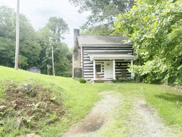 Feels like HOME! Check out this, what some consider, a historic cabin on 3.2 acres close to the trails with a creek running through it. The cabin sells furnished and has Chestnut logs and is currently used as a Airbnb and Vrbo. Serious inquires only. Pre approval/proof of funds required for showings and please no drive bys.