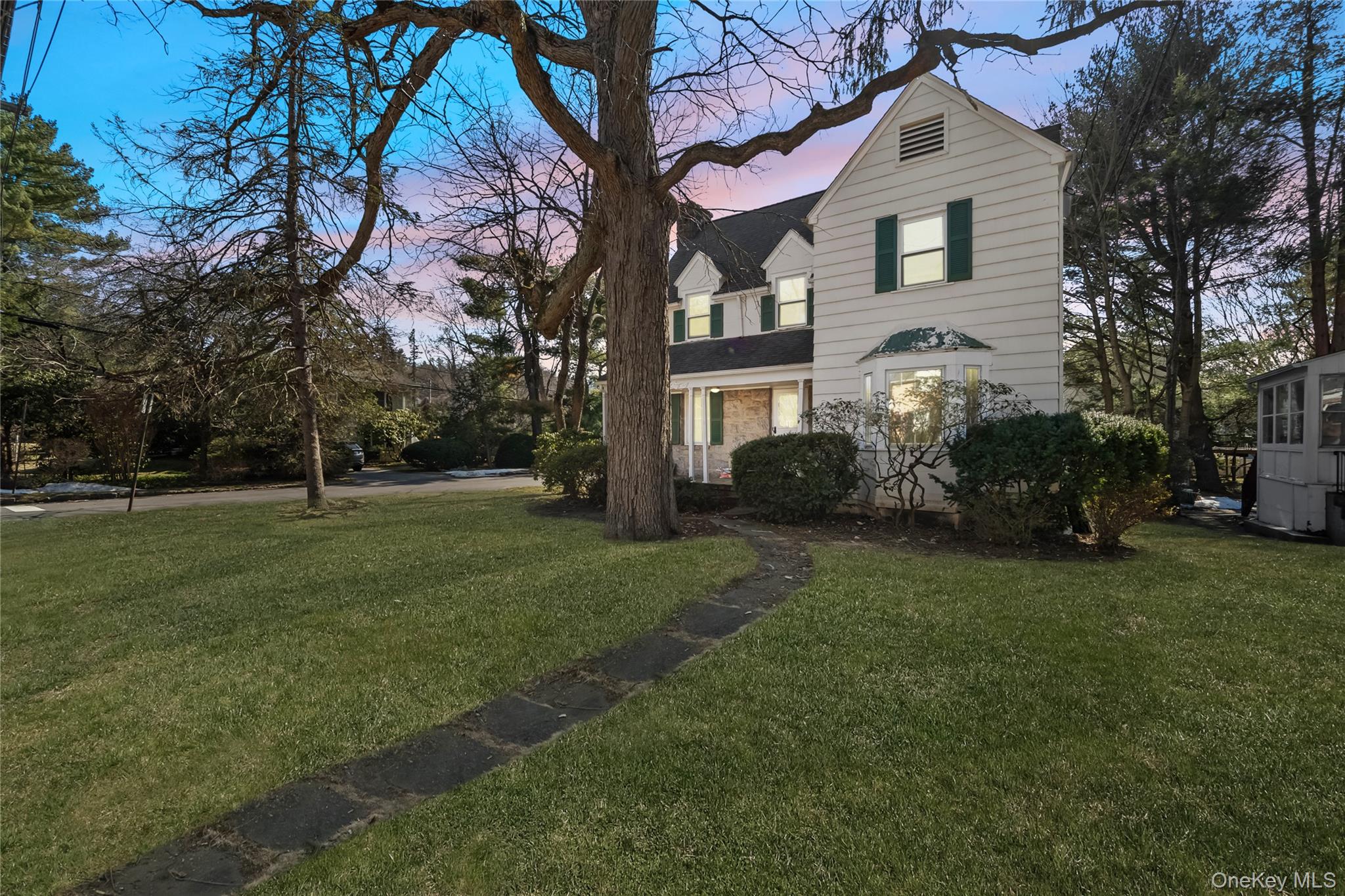This storybook Hartsdale colonial 3 bedroooms,2- 1/5 bathrooms with front porch is CLOSE TO EVERYTHING . Park,train,schools,worship,shopping and highways. Yet maintains the privacy and beauty of a quiet neigborhood. Enjoy the working  wood burning fireplace in the oversized living room and dinners in the formal dining room. Kitchen total refreashed about 6 years ago and new windows 1st and 2 nd floors about 6 years ago.Second floor Master bedroom has its own bathroom and Two nice size bedrooms with a  hall bathroom There are wood floors throughout and all bedrooms are of good size. Walk up stairs to Large unfinished  attic  perfect for home office,playroom, storgage etc and  ample basement storage. Basement is has 2 unfinished rooms.Laundry room is in the garage in a room in the back. One car garage with electric door openner.(NO washer yes dryer, microwave not working, NEW Roof in process of being installed-be careful while works are at the house , 100 amp electric service, oil tank in basement has been  professionally removed and disposed , wood burning fireplace not used in 10 years,Home Sold  "As Is Condition") Close to train, shopping, highways.  Get in and get settled just in time for the summer