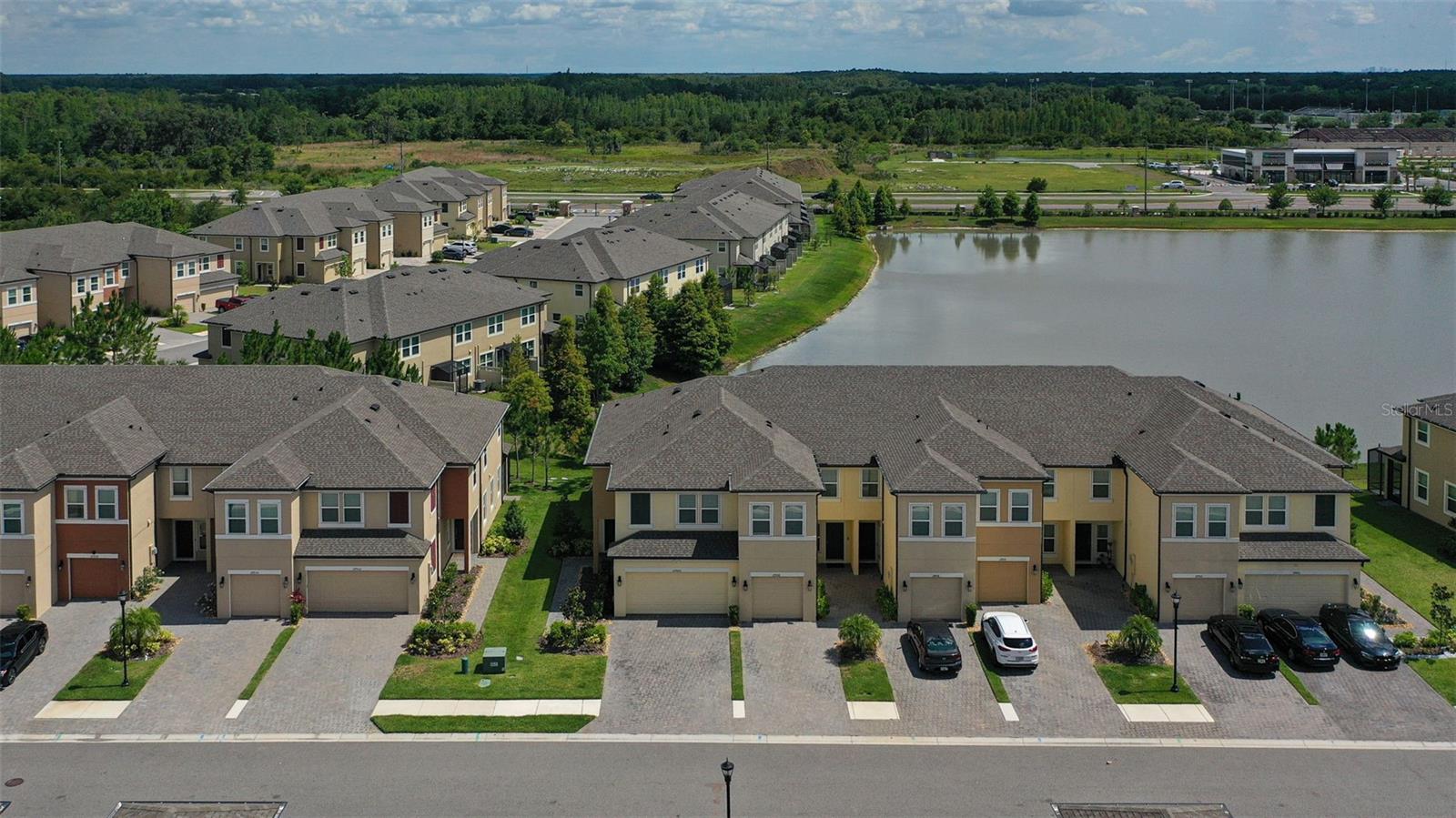 *** BUYER CAN HAVE A LOWER MONTHLY PAYMENT WITH AN ASSUMABLE VA LOAN AT 2.5% FIXED RATE WITH A APX $396k MORTGAGE BALANCE, CALL FOR DETAILS *** LIKE NEW & MOVE IN READY! Maintenance Free TOWNHOME! INCREDIBLE WATER VIEWS! The Perfect Place to call Home! This home is in the heart of Wesley Chapel sought after peaceful gated community of WINDERMERE ESTATES! HOME FEATURES a fantastic large open floor plan with 2,153 sq ft of great living space with 3 bedrooms, 2.5 baths & 2 car garage. Home is perfect for entertaining!Spacious open floor plan with living room, dining area & ½ bath & laundry room. Stunning large open kitchen with 42" cabinets/crown molding,stainless steel appliances, Island, quartz countertops, glass tile back splash, pantry, breakfast bar, upgraded lighting fixtures. Off the kitchen is a dining room area perfect for your dinner parties. The upstairs features spacious master suite with huge walk-in closet, full bath with large walk-in shower with beautiful tile work, dual sink vanity with quartz countertops. Large 2nd & 3rd bedrooms with spacious walk-in closet space also incredible bonus room. Spacious living room perfect for entertaining, also double slider glass doors opens to an outdoor covered screened Lanai that is perfect to relax, have your morning coffee or hang out with friends & family! Enjoy your Peace & tranquility backyard with STUNNING WATER VIEWS that invites you to sit & enjoy day & evenings. HOME ALSO FEATURES: water softener/filter system, reverse osmosis in kitchen,Ring doorbell & cameras, updated plumbing & lighting fixtures, ceiling fans, plenty of recessed lighting & MUCH MORE! The community features RESORT STYLE swimming pool. Low HOA fee includes: WATER, TRASH, LAWN MAINTENANCE, ROOF & EXTERIOR MAINTENANCE, PEST CONTROL.Close to all, Golf Courses, Publix, Shopping, Wiregrass mall, Premium outlet mall, Entertainment, The Groves, Restaurants, USF, Moffit, Flatwoods preserve, hospitals, minutes from Tampa Airport, downtown, all major highways I-275, I-75, I-4, schools and MORE! A MUST SEE! CALL FOR A PRIVATE TOUR.