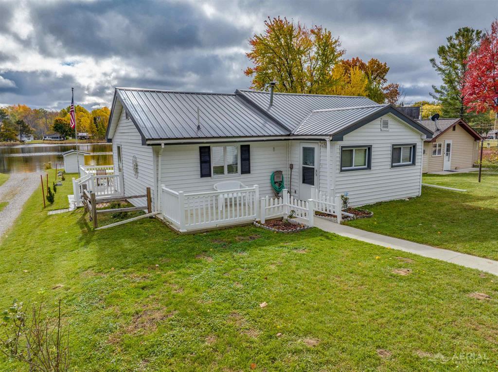 This 3-bedroom 1-bath home on Little Long Lake is ready for a new family to make up north memories. The level lot has plenty of room to play with grass up to the sandy bottom lake. The wrap around porch is perfect to catch the sunrise in the morning with a cup of coffee and the evening sunsets. Spacious eat- in kitchen with laundry. Detached two car garage. Cabin has been updated with fresh paint and carpet as well and the roof was done less than 5 years ago. Did we mention this is one of our quieter lakes with great fishing.