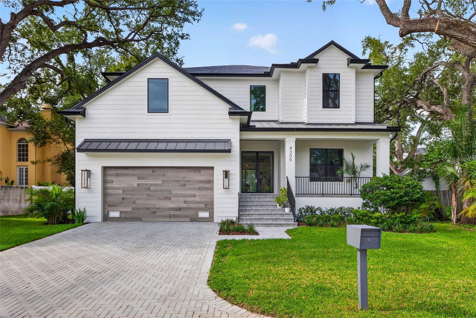 Under contract-accepting backup offers. Why wait for new construction when you can move right into a home that's barely a year old? Built by Momentum Homes, this exceptional South Tampa residence offers all the benefits of a nearly new home without the wait, blending timeless craftsmanship, elevated design, and a sense of playful luxury that's rarely found in new construction. With 5 bedrooms, 4.5 bathrooms, a dedicated office, and a spacious bonus room, this thoughtfully designed home offers the flexibility to grow, entertain, and truly live. Beyond the striking modern glass entry doors, warm oak ceiling beams, layered textures, and carefully curated finishes create a home that feels sophisticated yet welcoming. The grand living room is anchored by a custom dry bar with a wine refrigerator, setting the tone for effortless entertaining, while the open-concept layout flows seamlessly into a chef's kitchen designed to impress. Premium Thermador appliances—including a natural gas cooktop, built-in double wall ovens, refrigerator, and microwave drawer—are paired with ceiling-height shaker cabinetry, quartz countertops, under-cabinet LED lighting, an oversized island, and an expansive walk-in pantry. A thoughtfully designed mudroom just off the garage keeps everyday life organized, while the dining area enjoys picturesque views of the resort-inspired backyard. A private office at the front of the home creates the perfect work-from-home retreat, library, or flex space. Tucked away on the first floor, the guest suite offers privacy for visitors with a full bath that also serves as a convenient pool bath, while a beautifully appointed powder room completes the main level. Upstairs, the primary suite evokes the feeling of a boutique luxury hotel. An expansive custom walk-in closet offers exceptional storage, while the spa-inspired bath features dual vanities, marble flooring, floor-to-ceiling marble tile, an oversized walk-in shower, and a freestanding soaking tub designed for quiet moments of relaxation. Two secondary bedrooms share a beautifully finished Jack and Jill bathroom, while the fifth bedroom enjoys its own private ensuite. The spacious bonus room provides endless versatility as a media room, playroom, fitness studio, or second living space. Antique white wood flooring extends throughout the upper level, adding warmth, texture, and timeless character. Expansive sliding glass doors blur the line between indoor and outdoor living, opening to a covered lanai complete with a fully equipped outdoor kitchen. Overlooking the heated saltwater pool and spa, this backyard was designed for everything from lively gatherings with friends to peaceful evenings under the Florida sky. Built on an elevated stem wall for added peace of mind, this home also features PGT impact windows, two 16 SEER heat pump HVAC systems, and two tankless gas water heaters—delivering both efficiency and lasting quality. Perfectly positioned within the coveted Mabry, Coleman, and Plant school district, this exceptional South Tampa residence offers more than beautiful finishes and functional design. It delivers a home filled with warmth, character, and thoughtful details—where modern luxury feels inviting, every space serves a purpose, and every day feels just a little more elevated.