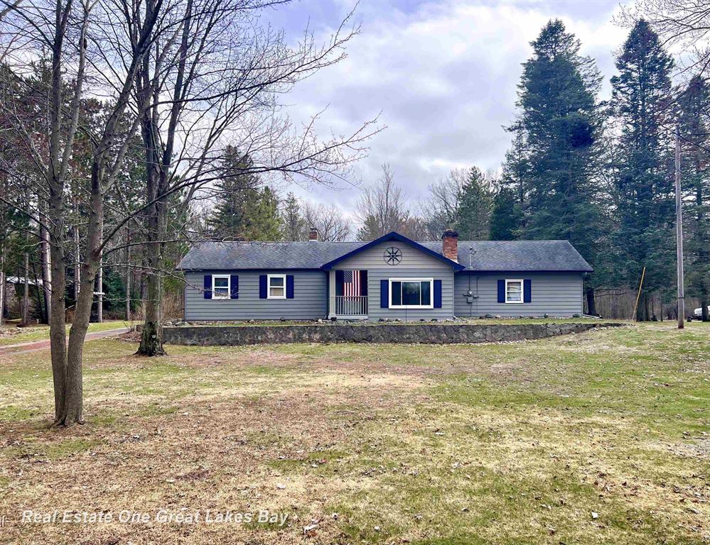 Welcome home to this beautifully maintained ranch in desirable Thomas Township, located within the highly sought-after Hemlock school district. This move-in-ready home offers a perfect blend of comfort, space, and country charm.  Inside, you'll find a warm and inviting living room featuring a cozy fireplace-ideal for relaxing evenings. The home includes three comfortable bedrooms and one and a half baths, providing plenty of space for everyday living.  Step outside to enjoy the expansive deck off the back, perfect for entertaining, grilling, or simply taking in the peaceful views of your private 6-acre property. The outdoor space is truly a standout, featuring a storage shed, an additional garage for equipment or a workshop, and tree-lined acreage with a scenic path leading to a charming tiny house. The tiny house is powered by solar energy and supplied with water, offering endless possibilities-whether as a guest retreat, hobby space, or your own private getaway.  From the front porch, enjoy tranquil views of the pond, adding to the serene setting this property provides. It's like having your own summer retreat right at home, all year long.  Priced at $284,900, this home is in move-in condition and ready for its next owner to enjoy everything it has to offer.