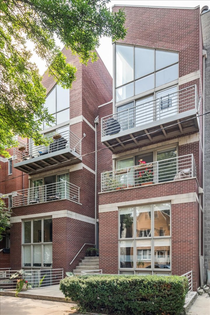 Sitting high in the treetops, this one of a kind 3 bed 3 bath West Town duplex up penthouse is ready for you to make it your home! Soaring 23' cathedral ceilings allowing natural light to pour into the living room, dining room and kitchen - all on the main level. Gleaming dark hardwood floors contrast beautifully with the chef's kitchen and stunning gas fireplace. Relax in your serene primary suite, complete with dual sinks, spa like shower and separate soaking tubs or enjoy your morning coffee on one of three private outdoor spaces including one off the primary. An additional bedroom, full bath and in-unit laundry round out the main floor. Upstairs, the sunlight continues to stream in thanks to an open loft perfect for work or working out! French doors lead you into the 3rd bedroom/flex space that features soaring ceilings, a full bathroom and a wet bar making this a great space for entertaining or a private retreat for guests! Located near everything West Town has to offer, you'll find yourself walking to dining and entertainment! Additional storage and parking are included with this fabulous penthouse.