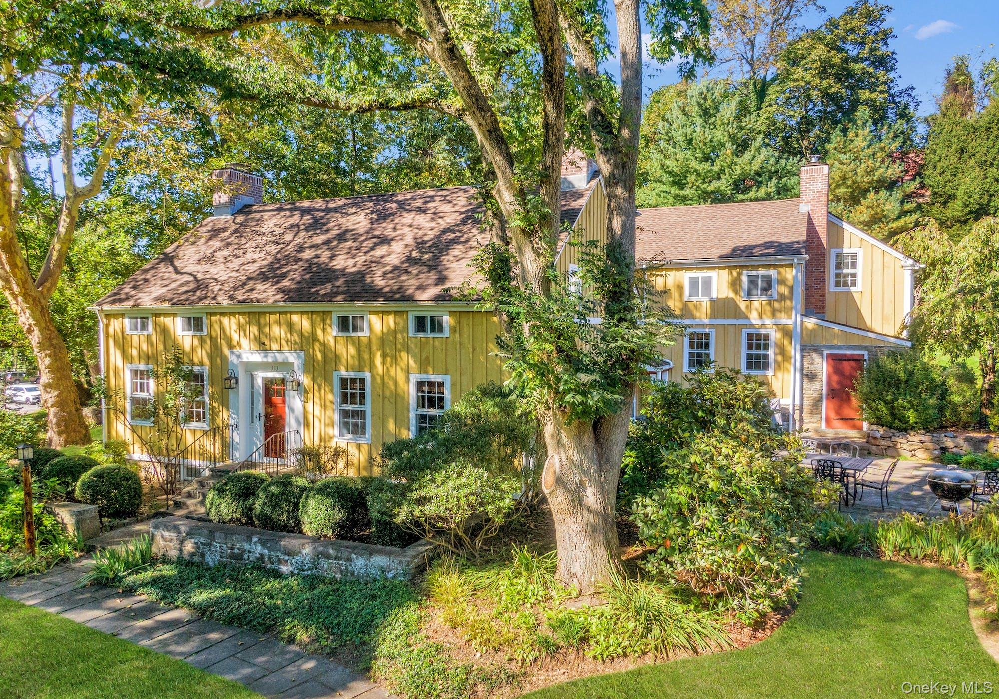 This is a rare chance to own a cherished piece of the historic Warburg estate. Set on two landscaped acres with an in-ground pool and beautifully layered grounds, Hill House offers the feel of a private retreat with the everyday convenience of being minutes from Metro-North and major highways. Built in the 1860s, this gracious Colonial blends original character with thoughtful updates that make it comfortable to live in today. Wide-plank floors, six working fireplaces, an old stone well, and an intact root cellar speak to the home’s history, while careful stewardship supports modern living. Rooms are generous yet inviting, with appealing nooks throughout—ideal for lively dinners in the large dining room, cozy movie or game nights, and quiet evenings by the fire. The layout also provides flexibility for today’s needs, including work-from-home space, a studio, or a private office suite. Outside, the property unfolds like a park: varied gardens, multiple seating areas, an expansive deck, open lawn for play and gatherings, established vegetable beds for serious (or aspiring) gardeners, and a large in-ground pool for long summer afternoons. A substantial garage adds excellent storage and workspace—well suited for hobbies, projects, or additional studio use. Outdoor lovers will appreciate having Hart’s Brook and Ridge Road parks nearby, with Rockefeller State Park Preserve, biking routes, Upper Westchester hiking trails, and River Town kayak launches within easy reach. From spring through fall, enjoy running or cycling along the Bronx River Parkway and weekends at the Hartsdale Farmers Market, plus nearby Rumbrook Park’s pickleball courts and trails. Shopping, restaurants, gyms, and other daily conveniences are close at hand. Hill House is a distinctive property—offering history, space, and a sense of calm, with a location that makes both weekend escapes and full-time living easy.