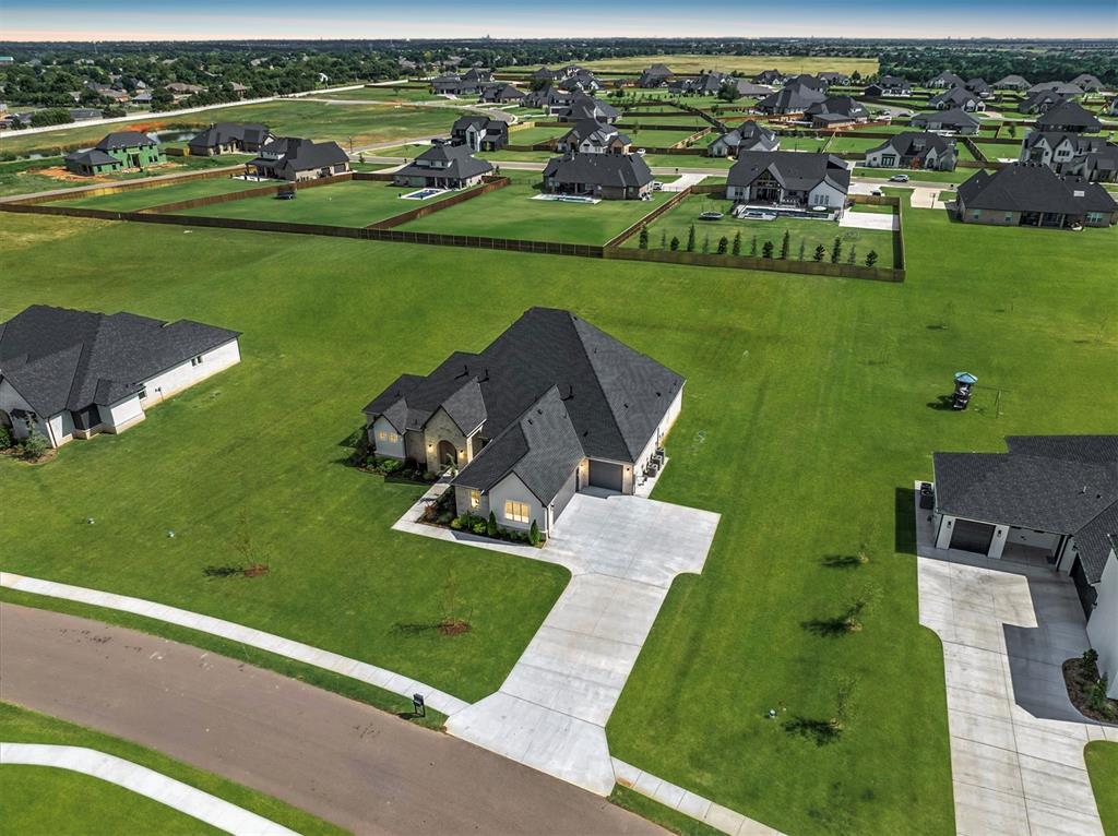 Allow us to open the door to your exceptional new home at 2270 NW 227th Street, where sophistication and comfort meet in perfect harmony. Located in the exclusive, gated community of Addington Farms, this residence is designed with an emphasis on elevating your lifestyle. The expansive first-floor living area is the heart of the home, thoughtfully designed to host gatherings in style. The main living room features an elegant coffered ceiling, a gas fireplace framed by a natural wood mantle, & stunning views of the meticulously landscaped backyard. The chef’s kitchen is a true masterpiece, complete with a grand island, a butler’s pantry, dual ovens, a convenient pot filler faucet above the range, & an abundance of counter space. An adjacent dining room provides the perfect setting for intimate meals or larger entertaining. On the left wing of the main level lies the opulent primary suite, designed for ultimate relaxation and luxury. Two separate vanities, a free-standing soaking tub, and a spacious walk-in closet with custom built-ins and a full-length mirror offer an extraordinary retreat. The second level is impeccably planned, featuring a versatile game/media room equipped with a beverage station, along with a guest bedroom and en-suite bath, providing privacy and comfort for visitors. Step outside onto the expansive covered patio, complete with a cozy outdoor fire pit. There is ample space to add a pool, should you wish to further enhance the outdoor experience. The home also features integrated speakers in both the main living area & the outdoor patio, enhancing your entertainment options. The property is equipped with premium utilities, including OG&E electric, ONG gas, a private well, an aerobic septic system, & private trash service. Deer Creek School District. Every detail of this home reflects captivating finishes and superior craftsmanship, offering an unparalleled living experience. Schedule a private tour today-- Welcome Home!