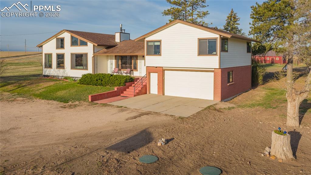 The Gresham Homestead is a turn key property with a spacious well maintained family home featuring 3,262 finished square feet, 4 spacious bedrooms and 3 bathrooms set on 25 level fenced acres just west of Elbert Colorado. The home is supported by several usable outbuildings and corrals. It is fenced and cross fenced into two pastures for rotational grazing. There are unbeatable views of Pikes Peak and the front range mountains. The land is well sodded improved grass pastures and ready for livestock. Incredible sunrises and sunsets. The property is in an area of larger farms, ranches and land parcels and gives the feel of wide open spaces and few neighbors. Nicely updated and well-maintained 4-bedroom, 3-bathroom home, on 25 ag-zoned acres, located 2.5 miles due west of Elbert, Colorado. The home features a spacious 3,932 square feet (3,262 sq ft finished) with a brick and wood siding exterior. Having been recently updated with brand new siding, 21 new windows, fresh paint, a 2.5-year-old roof, and a new septic system, the home offers comfortable, move-in-ready living. Main level highlights include the central living room with a stone fireplace and built-in bookshelves, a functional kitchen with plenty of cabinets, a large family gathering room with a gas stove and custom built-ins and a loft office and a south facing sunroom for your green thumb. The upper level features three nicely sized bedrooms, and a large full bathroom. The partially finished basement features a bedroom with egress plus a versatile game room/bar. With some work and additional plumbing, the basement could be converted to and accessory dwelling unit with the separate exterior entrance. The home features a west-facing partially covered deck to take in the Colorado sunsets, the Rocky Mountains and frequent “yard” deer or the Elbert Elk herd. The home sits among mature pine and deciduous trees and Lilacs in a mature yard. The home also features an attached 2 car garage.