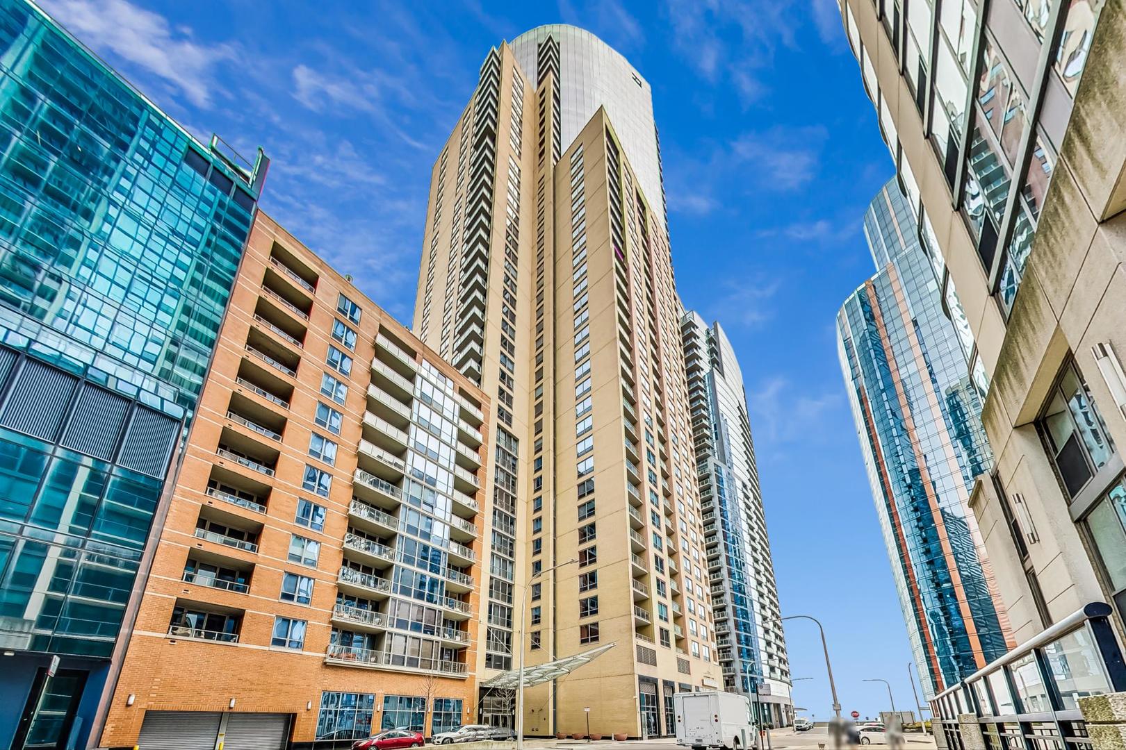 Luxury Living with Unmatched Views in the Iconic Regatta Condominiums. Experience refined city living, complete privacy, and breathtaking panoramic views of the lakefront, skyline, and Navy Pier from this masterfully customized 2-bedroom, 2.5-bathroom residence in the highly coveted Regatta. Every detail of this extraordinary home has been curated with sophistication and craftsmanship, offering a rare blend of elegance, function, and location. Upon entry, you're welcomed by a dramatic gallery foyer with upgraded designer lighting and rich wide-plank white oak flooring that flows seamlessly throughout the home. The expansive living and dining area is wrapped in North, East, and West exposures, delivering stunning natural light, iconic views, soaring ceilings, and direct access to a private balcony-perfect for entertaining or quiet reflection. The state-of-the-art chef's kitchen is a true showpiece, featuring top-tier appliances including a Wolf built-in oven, induction cooktop, and microwave, Sub-Zero refrigerator/freezer, ultra-quiet Bosch dishwasher, and a Kallista designer faucet. Custom cabinetry, sleek under-cabinet LED lighting, and striking 2-inch Bianca Perla quartzite countertops with full-height backsplash complete this exceptional culinary space.  The grand primary suite is a serene retreat with a walk-in closet and a spa-inspired en-suite bath featuring Calacatta quartz countertops, double Kallista sinks, a Kohler soaking tub, and exquisite Italian-imported Calacatta tile on both floor and walls. Floating custom cabinetry with integrated LED lighting elevates the luxury experience.  Additional features include a sophisticated powder room, high-end finishes throughout, and thoughtful custom storage solutions. Set within one of the city's most desirable lakefront residences, Regatta Condominiums offers full-service amenities including 24-hour door staff, indoor and outdoor pool, fitness center, sun deck, party room, and valet service. All situated in a peaceful enclave along the Riverwalk with a 4-acre park, Mariano's, and fine dining at your doorstep-just moments from Michigan Avenue, Navy Pier, and Lake Michigan. Parking spaces available for $45,000.