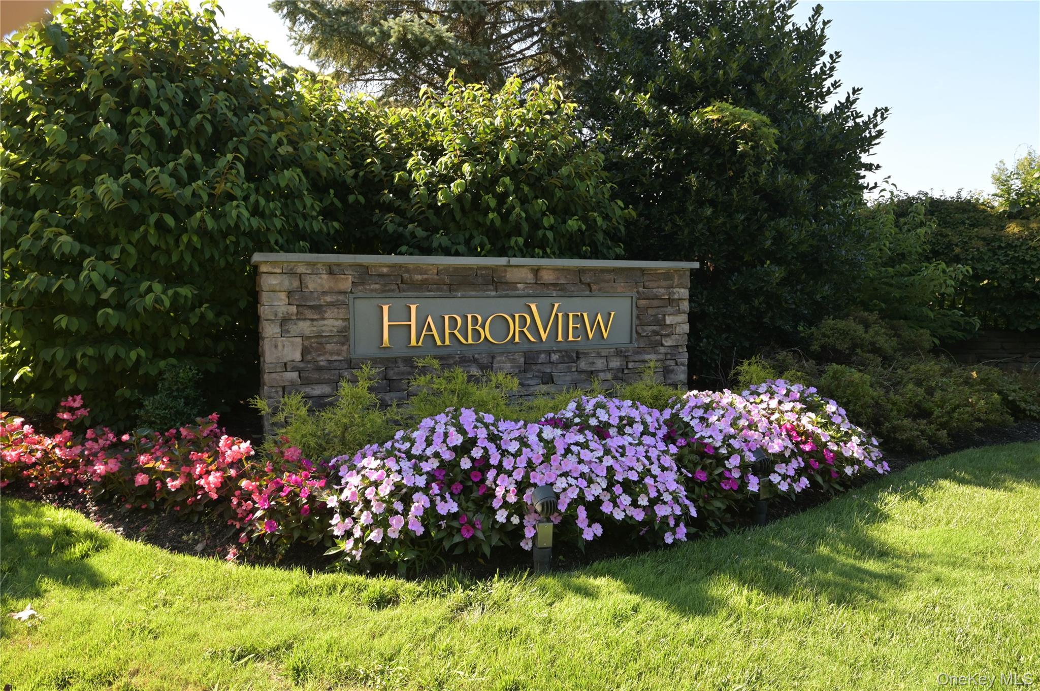Spectacular End-Unit Custom Condo with Panoramic Golf Course Views.  Originally configured as a traditional three-bedroom, this exceptional home has been masterfully transformed by a premier interior designer into an expansive two-bedroom retreat, thoughtfully redesigned to maximize space, privacy, and sweeping, uninterrupted views of the golf course. Every detail has been meticulously curated for refined living. The primary bedroom features 2 generously appointed full bathrooms an integrated sitting area with dedicated desk space, and lavish, high-capacity custom closets throughout. The completely redesigned kitchen is a true showpiece, showcasing top-of-the-line appliances, bespoke cabinetry and stunning quartz countertops. A custom-built dining area has been seamlessly integrated into the design maximizing space while creating an elegant setting for entertaining and hosting. The multifunctional secondary suite offers exceptional flexibility and privacy. A custom-integrated Murphy bed provides effortless accommodations for overnight guests while preserving valuable everyday living space. The suite also includes a dedicated workspace and a full bath, creating an ideal guest retreat or versatile home office.  Sliding glass doors from primary suite as well as the living room to a beautiful terrace overlooking the Harbor Links Golf Course. The property includes two dedicated indoor parking spaces (#139 & #207), along with private storage unit #108.  Enjoy carefree, resort-style living in one of the North Shore's most sought-after 55+communities. Extraordinary array of amenities, including 24-hour concierge, fitness center, card and party rooms with both indoor and outdoor pools.  Ideally situated directly across from Bar Beach and adjacent to Harbor Links Gold Course, conveniently close to fine dining, premier shopping and the LIRR.