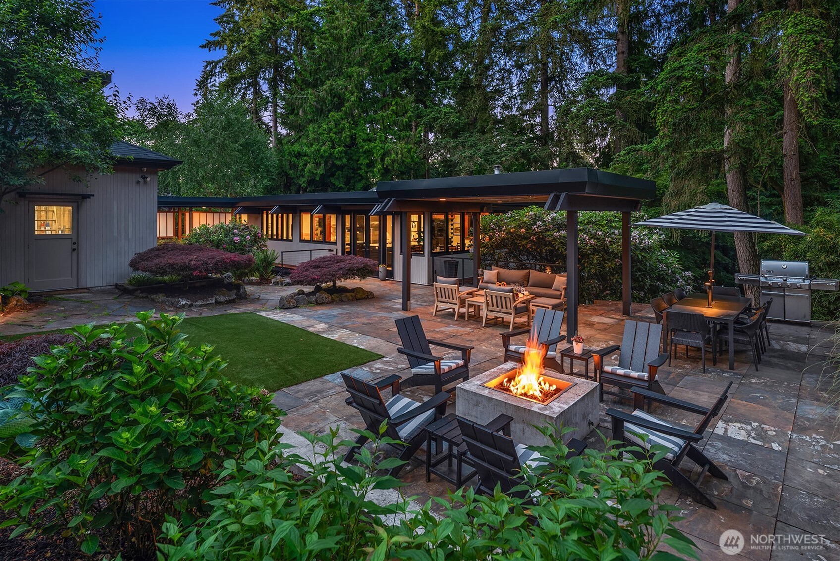 Fire pit lounge with covered outdoor living and grill