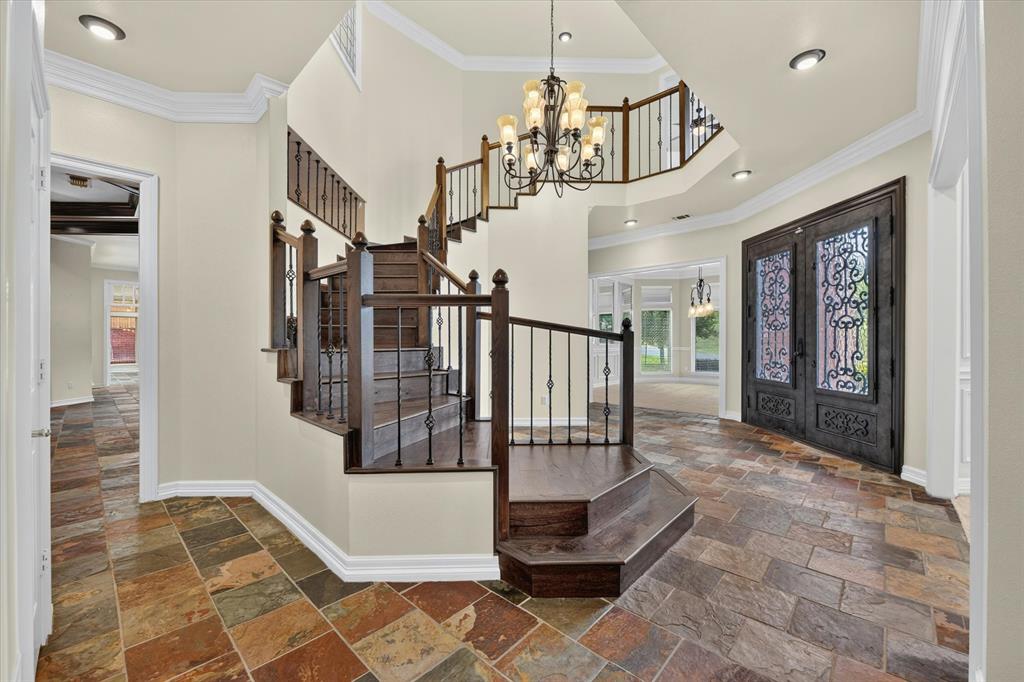 Privacy, space, and a lifestyle that's hard to duplicate in Arlington! Set on more than half an acre in gated Bay Club, this home offers over 5,700 square feet with a flexible layout ideal for entertaining, working from home, or multi-generational living. Inside, discover a dramatic two-story rotunda entry, multiple living areas, private study, sunroom, game room, and unexpected bonus spaces. Outside is where this home truly stands apart. Enjoy a private splash pool, multiple patios, entertaining pavilion, gated driveway abundant parking, and a workshop.  Minutes from Arlington's entertainment district, DFW Airport, golf and the lake, this is an opportunity to own a distinctive home in one of Arlington's established gated communities. Homes offering this combination of privacy, space, and flexibility are hard to come by. Schedule your private tour and experience 5811 Scenic Bay Ct in person.