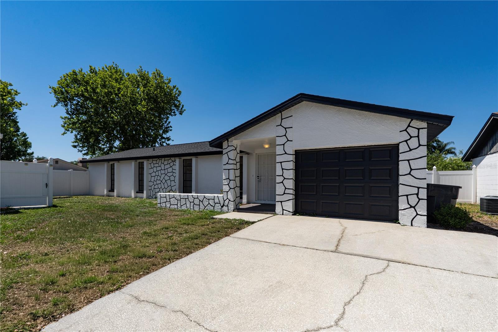 Fully remodeled 3 bed / 2 bath with 1,570 living sqft. This move-in-ready home features a bright open-concept layout with luxury vinyl plank flooring, recessed lighting, fresh interior finishes, and a beautifully updated kitchen complete with shaker cabinets, quartz countertops, stainless steel appliances, and sleek dark fixtures. The spacious primary suite offers a renovated en-suite bathroom and oversized walk-in closet, while both bathrooms have been tastefully redesigned with contemporary tile work and finishes. Major updates include a 2026 roof, 2025 HVAC system, and 2024 water heater for peace of mind. Enjoy the fully fenced backyard with plenty of space for entertaining, pets, or future outdoor additions. Conveniently located in Tampa near shopping, dining, schools, and major highways, this fully remodeled home perfectly blends style, comfort, and functionality! Schedule your private showing today!