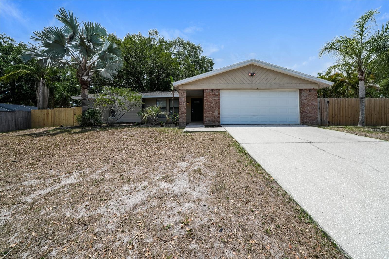 Don't miss your chance to own this gorgeous 3 bedroom, 2 bathroom, garage home tucked away next to Lake Tarpon in an established neighborhood on a corner lot!! This home has been beautifully updated through the years and features a freshly painted interior, great mixture of ceramic tile and brand new LVP for easy upkeep, multiple living areas, split floorplan, brand new granite countertops in the kitchen, updated bathrooms, new ceiling fans, and more!! Large, privacy fenced backyard perfect for your furry friends and enjoying the Florida weather. Roof replaced in 2021! Flood zone X! Beaches, Lake Tarpon Boat Ramp, Tarpon Springs Sponge Docks, and so much more only a short drive away! Top rated Schools! Don't miss your chance!