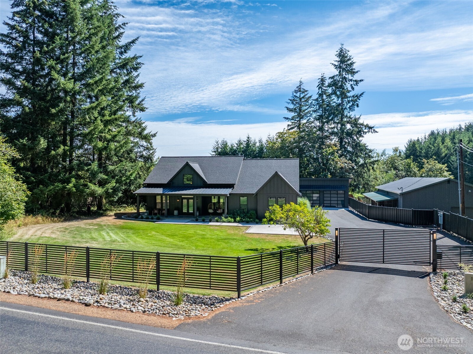 Rare opportunity to own a versatile multi-generational property offering exceptional space, privacy & possibilities! This unique property features 2 custom homes plus an additional apartment—ideal for extended living, guests, rental income or caretaker quarters. Approximately 11,000 SF of shop space provides incredible room for a home-based business, contractor, hobbyist, equipment, storage, or an impressive classic car collection. Multiple gated driveways offer privacy, security & convenient access throughout the property. A picturesque pond adds to the peaceful setting, while an additional lot offers potential for another home, creating even more possibilities for multi-generational living or future expansion. A truly unique property combining custom residences, massive shop space, business potential & room to grow—all in one remarkable setting! Be sure to check out all of the media and videos for this property to get the whole picture!