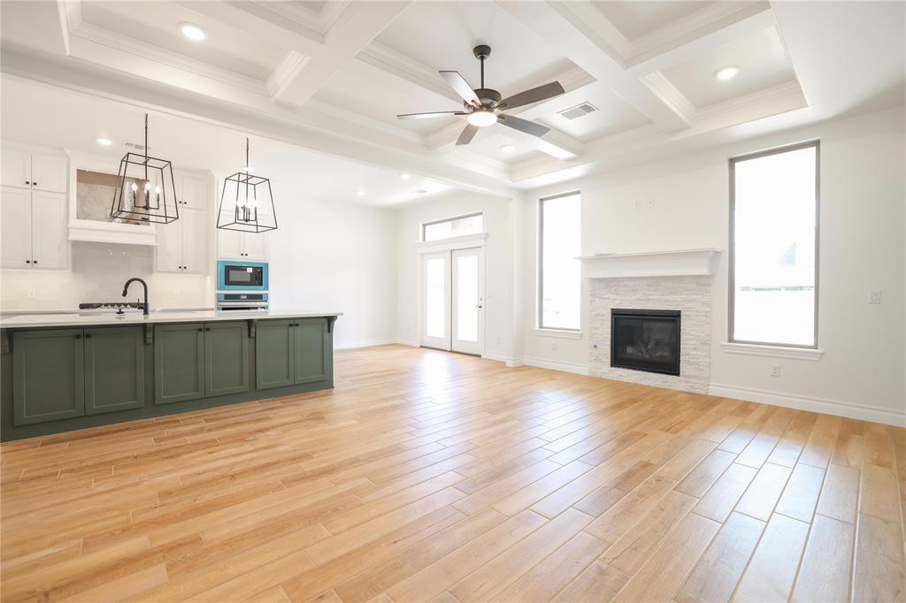 This Shiloh Bonus Room floor plan includes 2,805 Sqft of total living space, which features 2,450 Sqft of indoor living space and 355 Sqft of outdoor living space. There is also a 610 Sqft, three-car garage with a storm shelter installed because, at Homes by Taber, safety is never an option. This defining home offers 4 bedrooms, 3 bathrooms, 2 covered patios, and a large bonus room! The spacious living room features a stunning coffered ceiling with a ceiling fan, a stacked stone surround center gas fireplace, wood-look tile, large 7' windows, rocker switches throughout, and Cat6 wiring. The high-end kitchen supports custom-built cabinets to the ceiling, impressive tile backsplash, built-in stainless steel appliances, a center island equipped with a trash can pullout, impeccable pendant lighting, a walk-in pantry, and 3 CM countertops. The primary suite offers a sloped ceiling detail, windows, a ceiling fan, our cozy carpet finish, and 2 separate walk-in closets. The attached primary bath features separate vanities, a free-standing tub, a private water closet, and a huge walk-in shower! Property is fully sodded with an in-ground sprinkler system in both yards! The covered back patio offers perfection with its wood-burning fireplace, gas line, and TV hookup. Other amenities include Healthy Home technology, a tankless water heater, a whole home air filtration system, R-44 Insulation, and more!