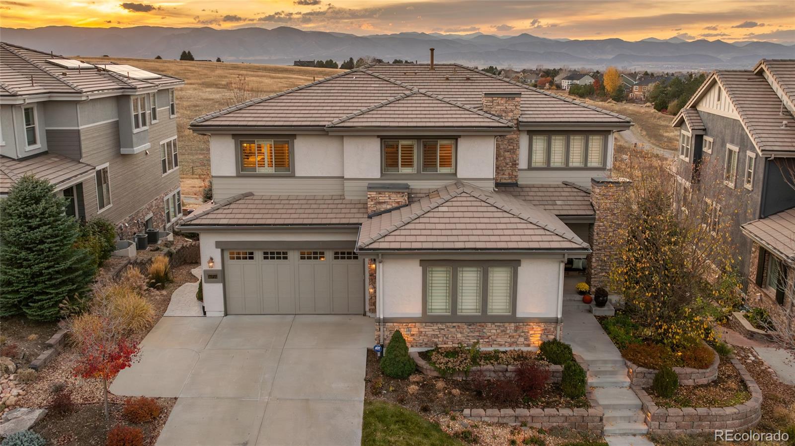 Set against open space with sweeping panoramic mountain views, this meticulously maintained home is in pristine condition. A welcoming foyer with a vaulted ceiling greets you upon entry, highlighting beautiful hardwood floors, custom millwork, and breathtaking views from the great room. The great room features built-in cabinetry, a fireplace, and flows effortlessly into an entertainer’s kitchen complete with a breakfast nook.The main level also includes a formal dining room with a fireplace, a bedroom ideal for a home office, and a bathroom. Upstairs, the spacious primary suite offers a spa-inspired bath with dual sinks and dual closets. The upper level is rounded out by a versatile loft, two additional bedrooms connected by a Jack-and-Jill bath, and a convenient laundry room.The recently finished lower level adds exceptional living space, featuring a large great room with a wet bar, a gym, an additional bedroom, and a bathroom. Enjoy Colorado sunsets from the covered deck or relax on the lower patio with a serene water feature. Step through the backyard gate for direct access to miles of trails, including a path leading straight to the elementary school. Embrace the Backcountry lifestyle with resort-style pools, a fitness facility, coffee shop, trails, parks, ponds, and so much more. Welcome Home!