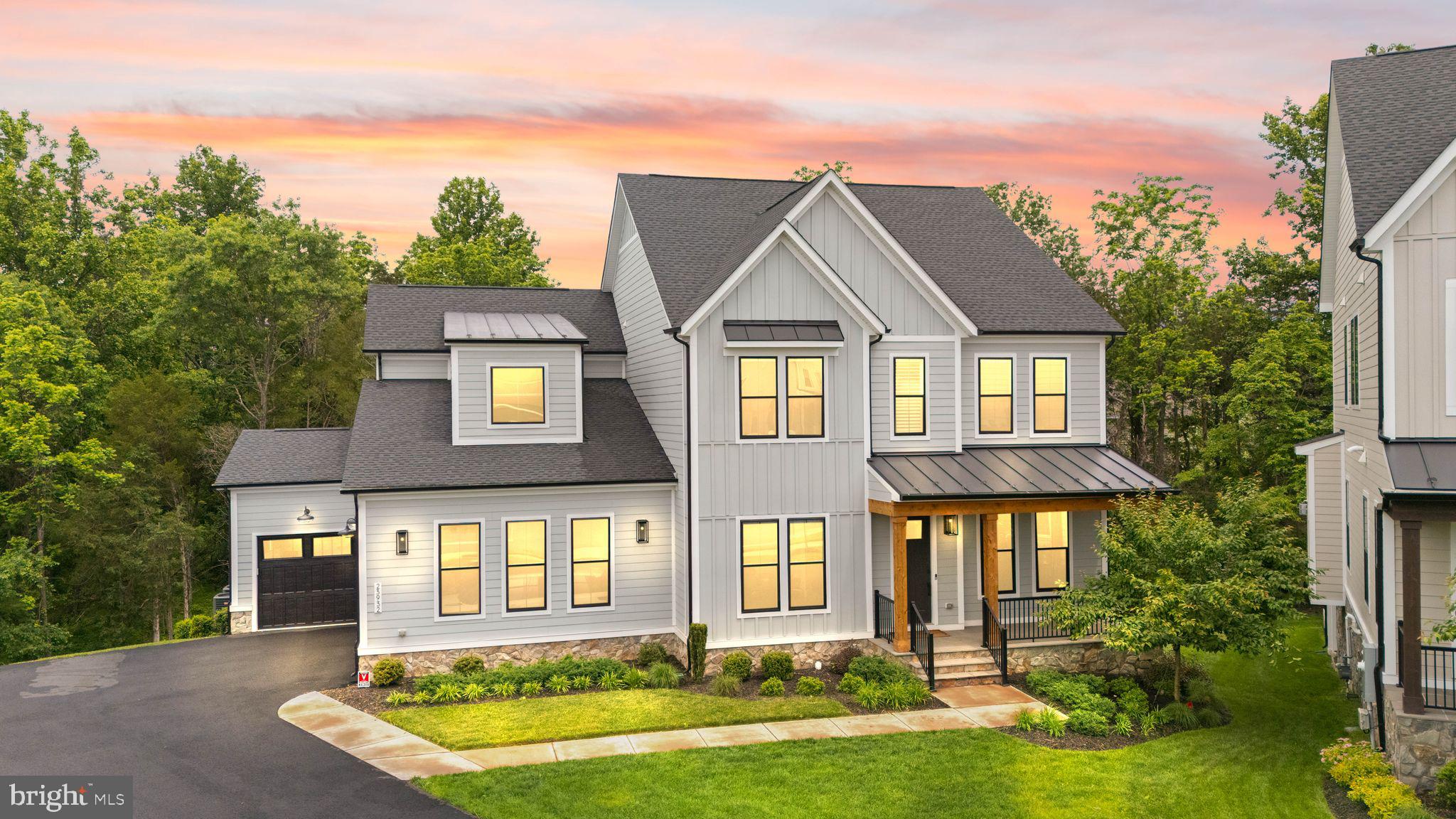 This stunning residence BACKS TO RARE TREED PRIVACY on a PREMIUM 0.43 ACRE CUL DE SAC HOMESITE in the sought-after community of HARTLAND. With over 5,200 finished square feet across three beautifully designed levels, this MULTIGENERATIONAL residence offers SIX spacious bedrooms (one BEDROOM ON THE MAIN LEVEL), 6 full bathrooms, 1 half bathroom, and a 3-CAR GARAGE thoughtfully prepared with an EV charging hookup. All three levels were extended at time of construction just three years ago, filled with natural light and enhanced by soaring 10-foot ceilings, creating luxury, comfort, and modern convenience. And just wait until you see the SCREENED PORCH!The main level is designed for both grand entertaining and comfortable everyday living, featuring a desirable main-level bedroom with private full bath, a lovely office with custom built-in bookshelves, and a stunning chef’s kitchen with quartz countertops, designer backsplash, white and grey cabinetry, walk-in pantry, and expansive gathering spaces. Enjoy birdsong from a screened porch overlooking the beautifully treed backyard that provides exceptional privacy and a peaceful natural setting. Upstairs, the luxurious primary suite serves as a peaceful retreat with a coffered ceiling, spacious sitting area, dual walk-in closets, and a spa-inspired bathroom featuring dual vanities, an oversized shower with built-in seating, and an elegant freestanding soaking tub. Additional upper-level bedrooms are generously sized and prewired for wall-mounted TVs. An upstairs laundry room with a sink adds everyday convenience.The WALK-OUT LOWER LEVEL offers incredible flexibility with a large club room, captivating WET BAR for entertaining or a fun movie night, an ADDITIONAL BEDROOM, plus two full bathrooms—ideal for guests, multi-generational living, guests, or extended stays. Along with the extensive spaces finished on this level, there is also plentiful storage space. Located in the amenity-rich Hartland community, residents enjoy access to resort-style amenities including a clubhouse with state-of-the-art fitness center, great room, playroom and locker rooms, as well as a competition sized pool, playground, plus tennis, basketball, and pickle ball courts. One of the walking trails leads to the historic, 35 acre Old Farm Winery!  Plentiful shopping, dining, top-rated Loudoun County schools, and Washington Dulles International Airport are nearby. Experience the comfort and peace of mind that come with owning a newer luxury home.Some of the many improvements the homeowners put into this home: 3-level extension, matte black metal roof accent, black windows, flagstone patio and walkway, stone water table, linear fireplace in the great room, executive wet bar in lower level rec room, ceiling junctions for future chandeliers and ceiling fans, recessed lighting, stylish window treatments throughout the home, built-in bookshelves in the office, sprinkler system in the front yard. It's all in the details, and these original homeowners display pride of ownership. Schedule your showing today!