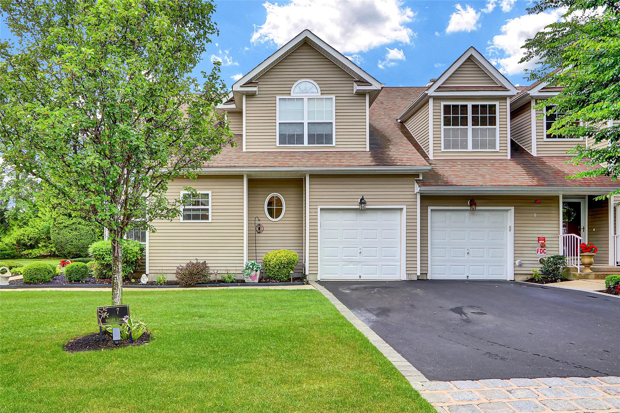Welcome to 7 Halley Lane, a beautifully maintained 2-bedroom, 2 1/2-bathroom townhouse nestled in the highly desirable 55+ gated community of The Vineyards at Miller Place. This light-filled home offers an open-concept layout with a spacious living and dining area, perfect for entertaining or relaxing in comfort. The kitchen features ample cabinetry, modern appliances, and a cozy breakfast nook.  The primary bedroom includes a large walk-in closet and en-suite bath while the second bedroom offers flexibility for guests or a home office. This meticulously landscaped community offers resort-style amenities including a in-ground heated pool, tennis and bocce courts, and a clubhouse featuring a sitting room, billiard room, and gym  — all just minutes from local shops and restaurants. Low-maintenance living at its finest!