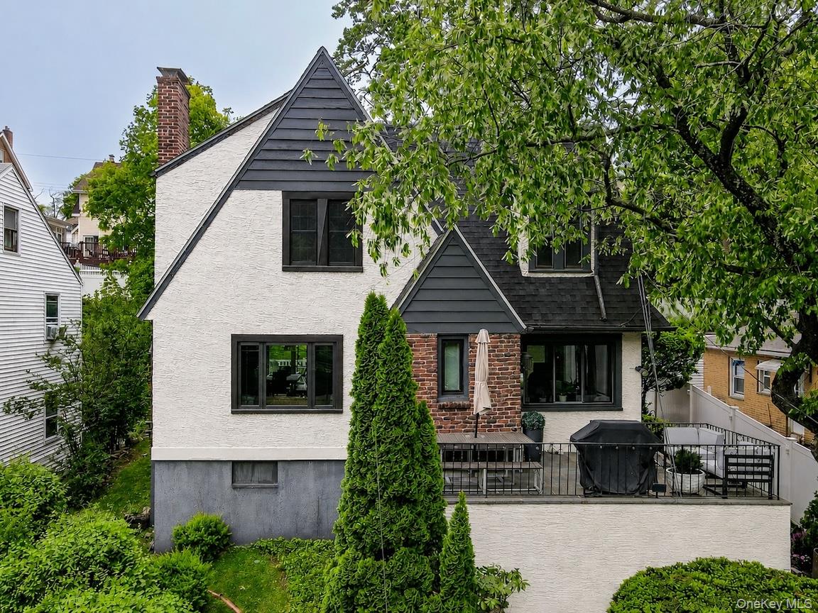 Sophisticated updates and charming architectural details define this completely move-in ready 3-bedroom beauty in Lincoln Park. This home will capture your imagination and your heart, as you enjoy the treetop views from the front terrace, tons of upgrades like ductless units throughout, a new furnace, a new deck with sliding glass door access from the dining room, new Anderson windows, a new step-in tiled shower, new pavers and professional landscaping, a fabulous mix of cozy settings and exquisite decor. Every aspect of this house brings its A-game, from the stylish windows to the signature fireplace which anchors the formal living room, an uber-tranquil sunroom that's exposed to light from three sides, and a chic kitchen with upscale appliances and a custom breakfast nook featuring banquette seating and views of the green, grassy yard. The private quarters offer three good-sized bedrooms, many closets, and a full hallway bath with magazine-worthy finishes.  The brand new deck is the perfect place to entertain in summer, or light the gas fire pit and roast marshmallows in winter. With hardwood floors throughout, classic Tudor arches and doors, modern lighting, shades, and built-ins, a handsome and superbly-maintained exterior and interior, an easy sprint to the city (Metro North and Wakefield MTA stations nearby) and access to the Croton Aqueduct path just around the corner (take it north to Tibbetts Brook Park, or south to Van Cortlandt Park), you can live the life you dream of, here!
