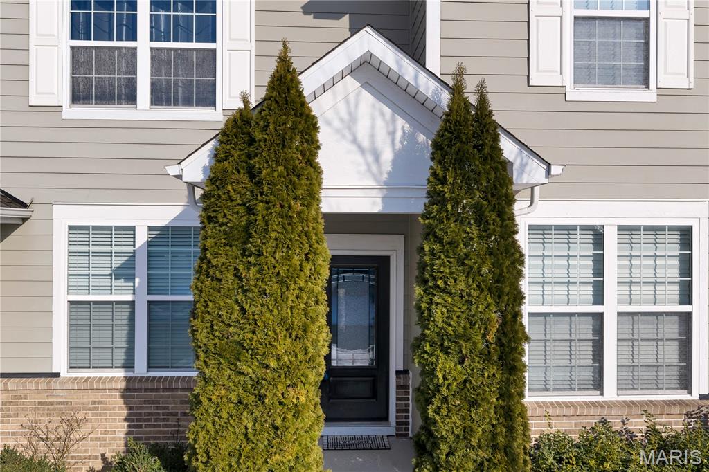 Located in the Estates at Town and Country Crossing, this 4-bedroom, 2.5-bath, 3,248 sf home combines contemporary elegance with everyday comfort in one of Chesterfield's most sought-after communities. Built in 2014 and carefully maintained, the residence reflects quality construction and attention to detail throughout.Rich hardwood floors flow through the light-filled main level, anchored by crown molding and an iron-spindle staircase. Formal dining and living areas are complemented by a gas fireplace, while the kitchen serves as the centerpiece with cherry cabinetry, granite countertops, glass tile backsplash, French door refrigerator, center island with seating, gas cooktop, double ovens, and a built-in desk area.Upstairs, the primary suite includes separate his-and-hers walk-in closets and a private ensuite bath. Three additional bedrooms and a full bath provide flexibility for guests, home office, or family living. Additional spaces include a main-level office or study, breakfast area, kitchen nook, and bonus room. The unfinished basement offers future expansion potential. Zoned HVAC, modern systems, and a 3-car attached garage add everyday comfort and convenience.Conveniently located near shopping, dining, schools, parks, and major highways, while offering privacy and a peaceful residential setting.