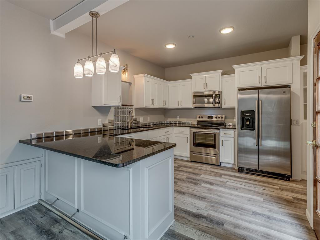 Welcome to low-maintenance living in the heart of North OKC! From the moment you step inside, you’ll feel right at home. This spacious condo has been thoughtfully updated to offer a fresh, modern feel while providing all the warmth and coziness you’re looking for. The main living area is bright and inviting, with fresh paint and stylish new flooring that flows seamlessly throughout the first level. The living area features a fireplace focal point, built-in cabinets and shelving, and plenty of natural light. The remodeled kitchen is truly the heart of this home, featuring brand-new cabinetry, updated countertops, sleek hardware, and contemporary light fixtures that add a touch of elegance to your daily routine. Leading into the kitchen is the dining area and updated bar. Also on the first floor is the powder bath both for your guests and everyday convenience. Upstairs, both bedrooms have been updated with plush, brand-new carpet, creating the perfect retreat for rest and relaxation. Each bedroom offers ample closet space, natural light, and a private bathroom, giving everyone plenty of room and privacy. This unit has a private open patio with a wood deck and gate for privacy. Step outside and enjoy all the perks of living in a secure, gated community. Spend your weekends lounging by the sparkling community pool, or gather some friends for a friendly match at the community tennis court. Beyond the amenities, you’ll appreciate the unbeatable location—Quail Springs Mall, Chisholm Creek, and countless local restaurants and shops are all just a quick trip from your doorstep, giving you endless options for fun and convenience. Major highways are nearby too, making your daily commute or weekend getaway a breeze.