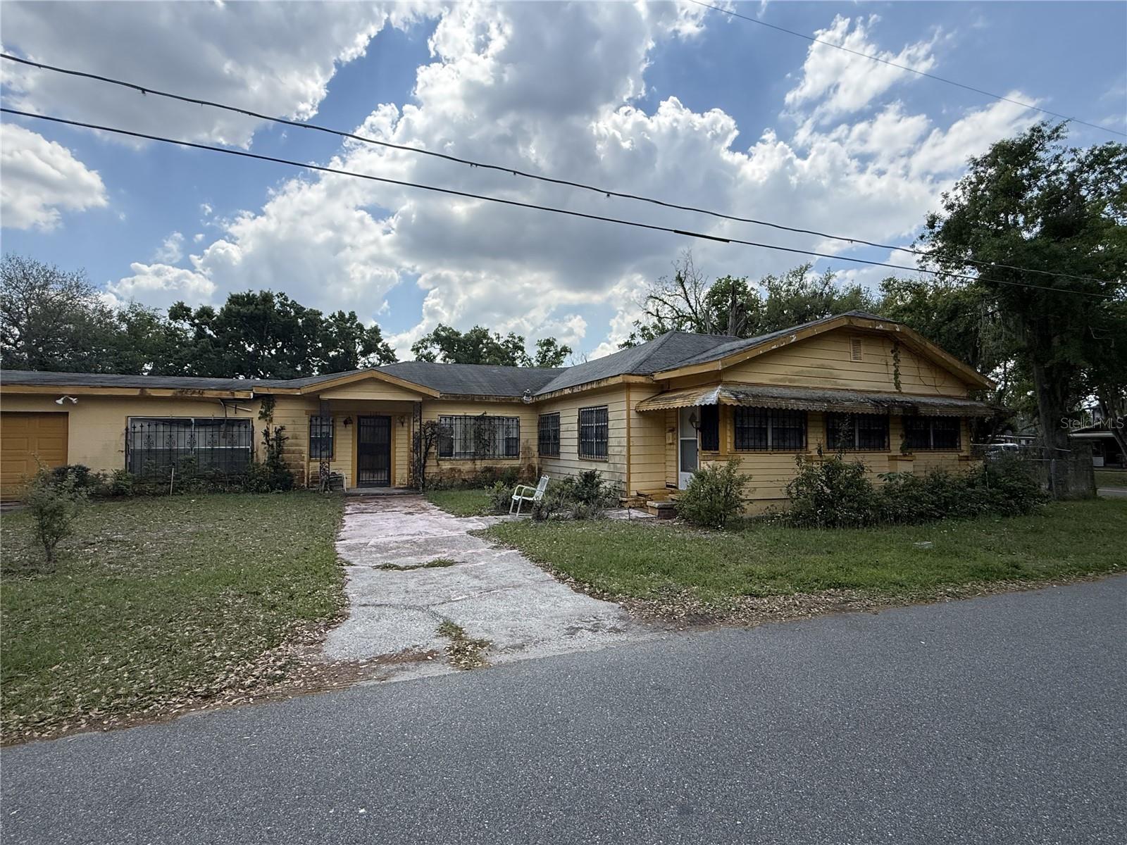 Located at 1101 E Jenkins St in Plant City, this 1930-built wood frame home sits on a corner lot just minutes from the heart of downtown. Offering approximately 2,334 square feet of living space on a 7,840 sq ft lot, this property presents a unique opportunity in a growing and revitalizing area.Enjoy close proximity to Downtown Plant City, known for its historic charm, walkable streets, and locally owned restaurants, boutiques, and coffee shops. The area is anchored by McCall Park, a central gathering space that hosts year-round community events, and the Robert W. Willaford Railroad Museum, adding to the town’s rich character and appeal. With easy access to major roadways, Plant City offers convenient commuting to both Tampa and Lakeland while maintaining a small-town feel.This property offers strong potential for redevelopment or renovation, especially given its corner lot and location. However, it is important to note this is a true fixer-upper that has been vacant for approximately 14 years. The home has known mold, significant water damage, hollow subflooring, and structural repairs needed in the primary bedroom due to an unlevel floor. A full rehabilitation will be required.Due to its condition, this property is best suited for investors or experienced renovators and will require cash offers only. The property is being sold strictly as-is, and the seller will make no repairs.