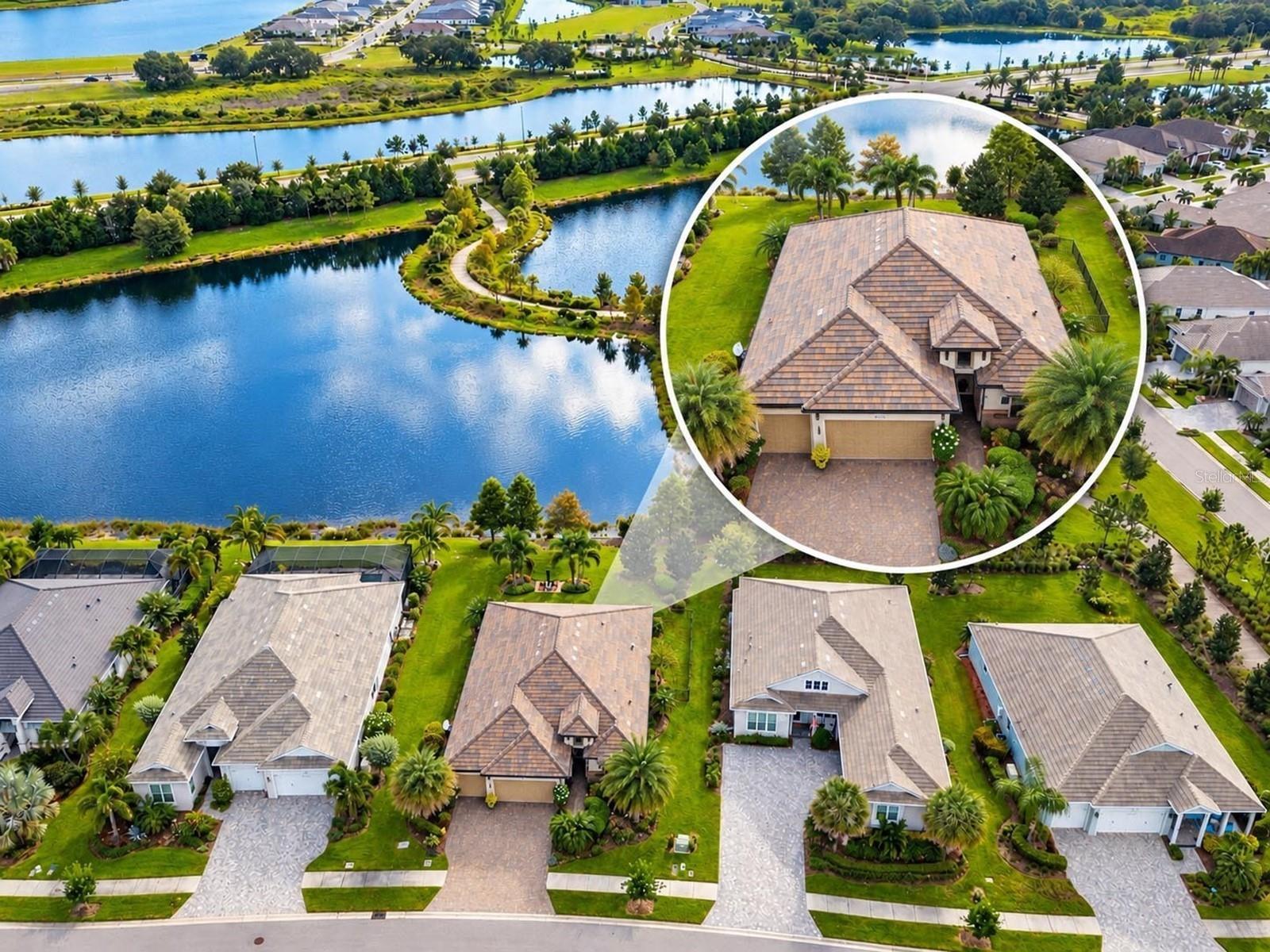 Welcome to 800 Tailwind Place, an exceptional residence in LakeHouse Cove at Waterside, Lakewood Ranch’s only waterfront Sarasota County village, where refined design, serene lake views, and resort-inspired amenities come together in one of the area’s most desirable settings. A paver driveway and walkway, elegant tile roof, covered front porch, and leaded-glass entry create an inviting first impression. Inside, plank-style tile flooring, a clerestory window, designer lighting, and a beautifully defined dining room introduce a sophisticated, light-filled interior. The main living area is anchored by an electric fireplace with built-in glass display shelving, a tray ceiling, and triple sliding glass doors that open seamlessly to the expansive screened lanai for effortless indoor-outdoor living. The open kitchen is equally impressive with a custom tile backsplash, natural gas cooktop, stainless steel appliances, double convection ovens, premium shaker-style cabinetry, walk-in pantry, and a generous center island with natural stone counters and bar seating beneath statement pendant lighting. An adjoining casual dining area features designer lighting and integrated buffet cabinetry with natural stone and extra storage. A private den with a sliding barn door and built-in desk adds flexibility, while the spacious laundry room offers cabinetry, sink, and convenient 3-car garage access. The thoughtfully separated bedroom layout enhances privacy, with the primary suite featuring lake views, a sitting area, dual vanities, and an upgraded large walk-in closet. Two additional bedrooms include plank-style tile flooring, ceiling fans, plantation shutters, and built-in closets, with access to a stylish bath featuring a walk-in shower and solid-surface vanity. A conveniently located half bath offers direct lanai access. Outdoors, the oversized screened and covered lanai with brick pavers, a ceiling fan, recessed lighting, and tranquil lake views extends the living space, complemented by a fenced dog run, lush tropical landscaping, and a lakeside paver patio. Set amid seven lakes, nature preserves, and more than 20 miles of shoreline, LakeHouse Cove offers maintenance, including lawn care, along with an impressive collection of amenities including a clubhouse, fitness center, resort-style pool, white-sand beach, fire pits, six pickleball courts, bocce, dog parks, playground, event lawns, boathouse facilities, reservable single and tandem kayaks, scenic multi-use trails, and boat-taxi service connecting to Waterside Place. Nearby Waterside Place brings dining, shopping, coffee, boutiques, weekly markets, live music, movies, and community events to the lakefront, while the greater Lakewood Ranch lifestyle offers exceptional golf opportunities and proximity to the renowned Sarasota Polo Club. Convenient access to University Parkway, I-75, UTC, Sarasota-Bradenton International Airport, and downtown Sarasota. Additional upgrades include energy-efficient A/C, whole-house water filtration, hurricane-impact glass, smart-home automation with alarm, EV charging, enhanced air filtration, extensive landscaping, and exterior insect control. 800 Tailwind Place delivers a polished blend of luxury, comfort, recreation, and the distinctive waterside lifestyle.