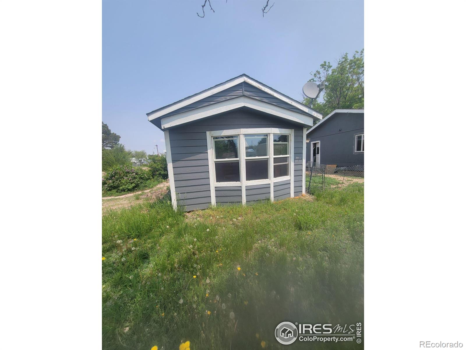 Large 14,000 sq ft lot has a mobile home on the property (mobile home does not have a title). Mobile home is a 2 bedroom + 2 full bathrooms along with a 2 car detached garage. The land is located on a large corner lot. Owner will carry - terms:$5,000 down + 2 points origination 9% interest only payments w/ a 5 year balloon. All information deemed reliable but not guaranteed, Buyer and/or Buyer's agent to verify all information.