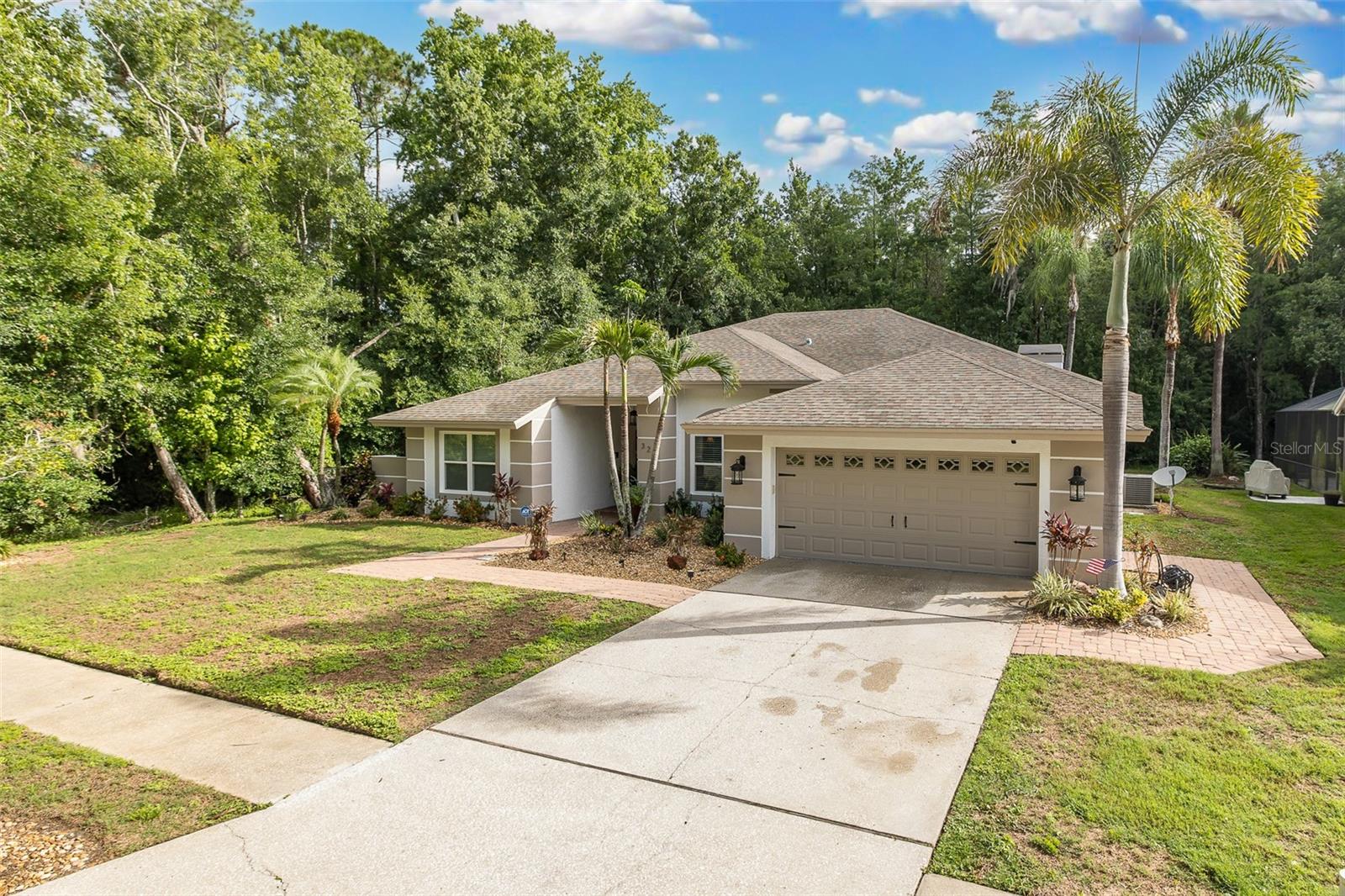 Exceptional East Lake Home in the Desirable Woodfield Community! Tucked away on a private conservation lot with only one neighbor, this stunning 4-bedroom, 3-bathroom home offers the ultimate in privacy and refined living. Completely updated from top to bottom, the home showcases beautiful travertine flooring flowing seamlessly throughout all living areas, complemented by thoughtful architectural details that truly set this property apart.The chef-inspired kitchen impresses with rich wood cabinetry, gleaming granite countertops, and stainless steel appliances. The spacious family room is an entertainer’s dream, anchored by a classic wood-burning fireplace perfect for cozy gatherings. The oversized primary suite is a true retreat, featuring a separate sitting area with stunning ceiling details and serene views of the private backyard. The en suite bath has been beautifully upgraded with wood vanities, a relaxing soaking tub, and a separate shower. All secondary bedrooms are generously sized, and the guest bathrooms have been tastefully updated throughout. Step outside to your own private paradise — an oversized pool overlooking a gorgeous conservation backdrop where wildlife and nature are on full display every day. Recent updates include fresh interior paint (2023), fresh exterior paint (2025), new lighting and ceiling fans (2023), new custom blinds (2023), new lanai cabinetry (2023), new pool equipment including motor, pump, and salt system (2023), whole-house water softener and filtration system (2023), new appliances (2023), new hurricane-insulated garage door, newer high-impact double-paned windows, and a newer central vacuum system. Located in the highly sought-after East Lake Corridor and zoned for top-rated Pinellas County schools, this home is just a short drive to stunning Gulf beaches, Tampa International Airport, and St. Pete/Clearwater Airport. This is a rare opportunity ~ homes like this seldom pop up!!