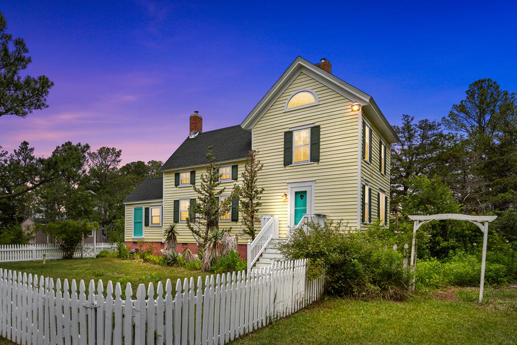 This beautifully maintained home blends timeless character with modern comfort, featuring updated kitchen and bathrooms, newer HVAC, tankless water heater, and septic system, along with original details that reflect its coastal heritage. Multiple outbuildings include several storage sheds, a workshop with electricity and a cozy wood stove, and a detached studio overlooking a tranquil pond—ideal for an artist's haven, guesthouse, or future in-law suite. Nestled on 4 serene acres teeming with wildlife and natural beauty, the property offers direct water access, a private dock, and calm tidal creeks. Note: Sale includes Parcel 83-A-33 only; Parcel 83-A-33-A is not included.