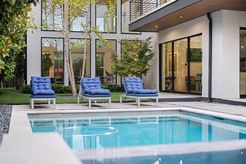 Offered for the first time, this stunning modern masterpiece was thoughtfully built as a forever home. Set behind a massive iron gate & mature landscaping, 423 W. Colorado Blvd is a secluded sanctuary where the city fades away. Built in 2021, this home perfectly blends nature with absolute luxury. Ascend the elevated steps into your own private retreat where natural light floods the entire space. With 51 windows throughout, you get stunning 360 degree views of glass & greenery at every turn. The living room is a showstopper featuring 19 ft ceilings, gorgeous limestone fireplace, & floating stairs that double as art as the sun moves across the sky. Entertaining is effortless in the kitchen where massive custom glass sliders disappear into the wall, seamlessly connecting your indoor space to the spectacular pool area. This kitchen is a dream with a premium Thermador appliance package, a huge quartz island, & a hidden butler pantry. For flexibility, you will love the den. Serving perfectly as 2nd living area or easily functioning as a 4th bedroom if needed, this versatile space features solid core pocket doors, a walk in closet, & a full bathroom conveniently located right around the corner. When it is time to unwind, take the commercial White Oak elevator to your primary suite. Here you will find a beautiful limestone accent wall & a gorgeous spa bath complete with a relaxing garden tub, dual shower heads, & a central rainfall shower. Step out onto your wraparound balcony to overlook your peaceful backyard. Continuing upstairs, another incredible space awaits with spectacular downtown views perfect for watching 4th of July fireworks. Outside, the backyard is an absolute dream featuring a heated pool, an attached spa, & beautiful green turf. A full home Sonos system plays your favorite tunes inside & out, setting the perfect vibe.