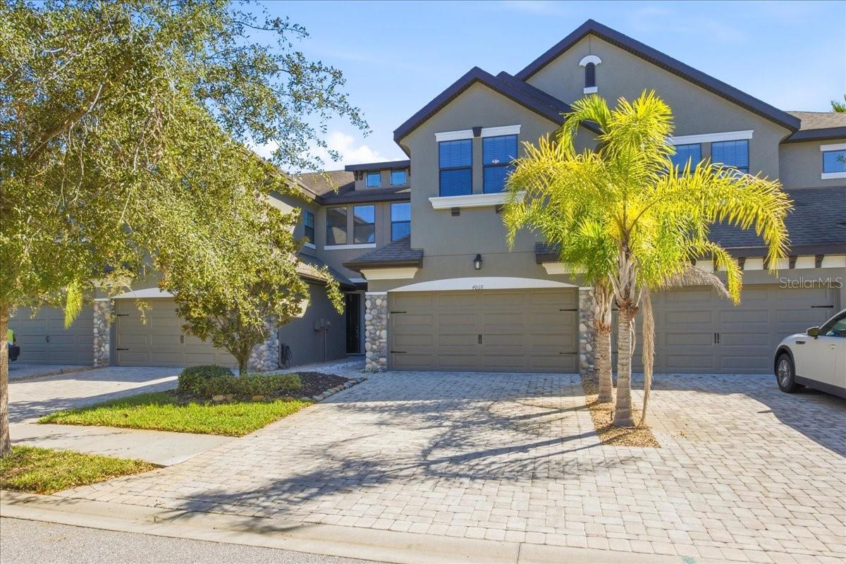 WELCOME HOME TO WESLEY CHAPEL! Style, comfort, and convenience come together in this inviting 3-bedroom, 2.5-bath townhome offering 1,748 square feet of living space, thoughtful upgrades, and a private screened lanai. Step inside to discover a bright, welcoming interior with neutral tones and an open-concept floor plan designed for everyday living and entertaining. The spacious living room features a cozy electric fireplace and is wired for surround sound, creating the perfect setting for relaxing evenings or movie nights at home.The kitchen is both stylish and functional, featuring 42-inch cabinetry, soft-close drawers, convenient pull-out storage, a brand-new GE Profile smart refrigerator, generous counter space, and a center island. The adjoining dining area provides an inviting space for gathering with family and friends.Step outside to your private screened lanai, a natural extension of your living space. Recently painted and enhanced with exterior landscape lighting, it's the perfect spot for morning coffee, evening relaxation, or entertaining friends. The outdoor television conveys with the home, making this space ready to enjoy!Upstairs, retreat to the spacious primary suite featuring an elegant tray ceiling and two walk-in closets. The ensuite bathroom offers dual vanities, a relaxing garden tub, and a newly installed remote controlled window shade for added privacy and convenience. Two additional bedrooms provide flexibility for guests, a home office, or additional living needs.Residents can also enjoy the pond, dog park or community swimming pool surrounded by tropical landscaping.Thoughtful upgrades include new dual zone smart thermostats upstairs and down, privacy locks added on the bathroom pocket doors, remote control shade in master bath, new smart locks on exterior doors, new landscape lighting front and back, new smart locking/motion garage control panel sensor, new overhead storage racks in garage...along with tool/cabinet storage system placed on the wall. New Fiber optic to home (up to 7 gig capable).  Kenmore front-load washer and dryer are also included. Water heater 2025, A/C compressor 2024. Roof 2016. All Furniture negotiable. LOCATION, LOCATION, LOCATION! Situated in desirable Wesley Chapel, this home offers convenient access to I-75, along with shopping, dining, entertainment, major roadways, Baycare Wesley Chapel, AdventHealth hospital, Orlando Health, and the new YMCA. Combining spacious interior, thoughtful upgrades, and inviting outdoor living, this townhome offers an exceptional opportunity to enjoy the Florida lifestyle.Your next chapter begins at 4868 Wandering Way. Schedule your private showing today!