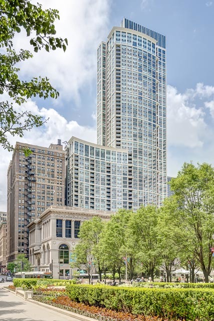 Enjoy spectacular wraparound views of Lake Michigan, Millennium Park and the city skyline from this one-of-a-kind 4,350SF custom designed home, all on one level, at the Heritage At Millennium Park!  This home was exquisitely designed with top-of-the-line finishes and the open floor plan is perfect for relaxing at home and entertaining. Inviting rotunda foyer with dome ceiling leads to expansive living and dining areas with sweeping views of Lake Michigan and Millennium Park. Library features a dual-sided gas fireplace with Absolute granite surround and custom cherry built-in wall unit with bookcases. Open, eat-in chef's kitchen has custom cabinetry, Labrador Gold granite countertops and backsplash, high-end appliances (Subzero, Wolf, Miele), Subzero wine refrigerator with two drawers, walk-in pantry and large southeast facing balcony. Expansive den has wet bar area with refrigerator, sink, ample storage and counter-seating which is great for enjoying a movie and entertaining at home. Adjacent study has custom built-in desk-wall unit, storage and 2nd laundry. Spectacular master suite has office, luxury spa marble bath with dual vanity, whirlpool bathtub and separate dual steam shower, walk-in closet, walk-in laundry room with new Bosch washer-dryer and beautiful east views. 2nd bedroom has en-suite bathroom with oversized full-height marble shower. 3rd bedroom has corner windows, private west facing balcony and gorgeous day and sunset views of the city. 3rd bathroom has marble tile and oversized full height shower. Foyer coat closet and unique designer decorated powder room. Special features o this home include floor-to-ceiling windows, fully integrated Lutron lights, motorized shades and Crestron sound video system, surround sound, recessed lighting, 3 entrances and 2 humidifiers. Well managed, full amenity building with 24hr doorman, on-site management, concierge service, indoor pool with hot tub, steam sauna, 3 outdoor terraces, exercise room, party-conference room, receiving room, dry cleaner, dog run, storage, bike storage, direct access to the Pedway, and more! Walk to the lakefront, Millennium Park, Cultural Center, restaurants, theaters, symphony, shopping, museums, transportation and more! 1 deeded parking space 5-36 available at $35,000. 2 full-height storage lockers included.