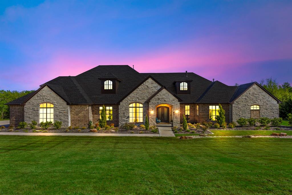 Welcome to an exquisite retreat in The Hills of Lone Star, where luxury and privacy meet on 2.85 acres of serene, tree-lined land. A grand stone-pillared driveway with custom lighting leads to an impressive 4-car garage, while ornate iron double doors open to a breathtaking interior featuring hardwood floors, cedar beams, and designer lighting. The chef's kitchen, complete with a working pantry and top-of-the-line appliances, Flows seamlessly into the grand family room with a stone fireplace and beam ceiling, while sliding glass doors extend the living space to an outdoor kitchen and smoker, perfect for entertaining. Designed for comfort, the home boasts a private owner's retreat, with a spa-like ensuite, three guest suites with ensuite baths and walkin closets, and a separate in-law suite with a kitchenette. Upstairs, an elegant great room with fireplace, gym, office, and balcony with cedar ceilings and tile flooring provide additional space to relax and enjoy breathtaking views, while a beverage cooler and beer tap, a backyard pre-wired for a pool and spa, a gym pre-wired for a sauna, and a generator ready system for peace of mind. Experience the perfect blend of sophistication and comfort in the 7,300+ square foot custom masterpiece -- welcome home to The Hills of Lone Star!