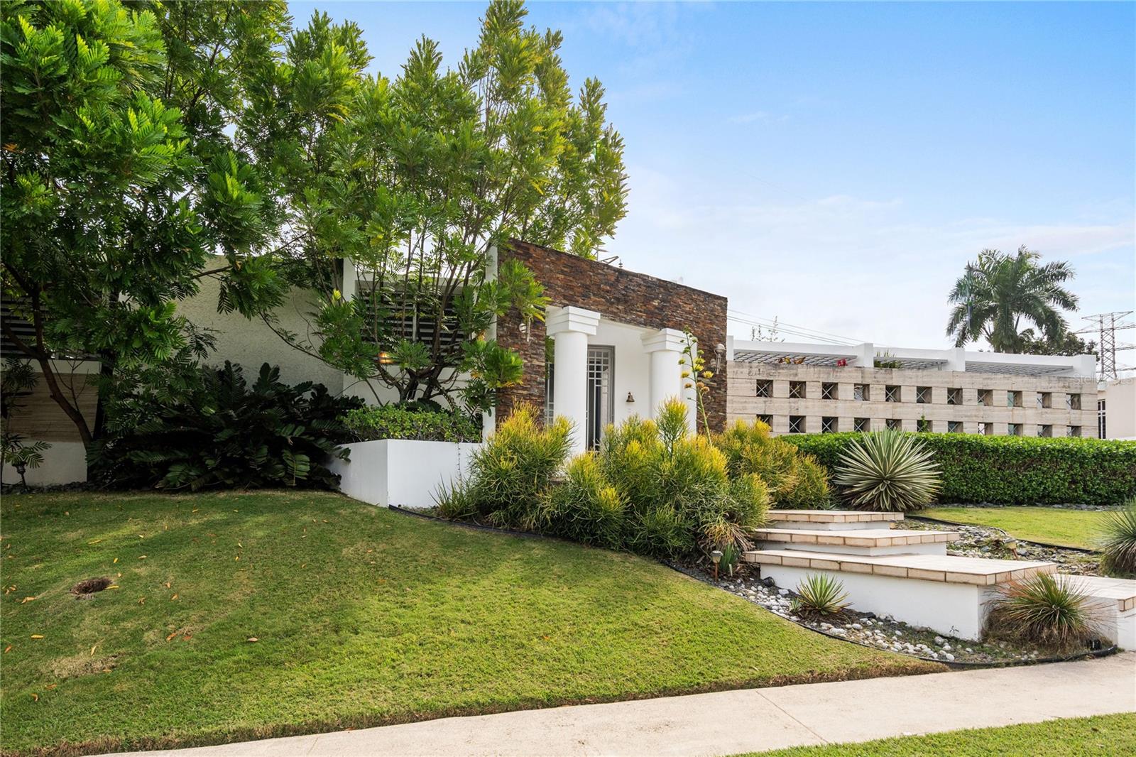 Located within the gated community of San Ignacio in San Juan, this single-story residence offers 3 bedrooms, 3,488 square feet of interior living space, and sits on a 1,316 square meter lot. The layout connects the living and dining areas seamlessly with the kitchen and extends to a covered terrace with a wooden deck, creating a natural indoor and outdoor flow that works equally well for everyday living and for hosting gatherings.A versatile bonus room provides flexibility for a home office, gym, media room, or additional living area. The property also includes a dedicated storage room and covered parking for four vehicles between the garage and carport, along with additional covered space that can be adapted for recreation or entertainment. A full-power generator services the entire residence, offering reliability and continuity year-round.San Ignacio is a well-established gated community recognized for its controlled access and residential environment, conveniently located near leading private schools, established dining options, and major shopping centers, providing accessibility within one of San Juan’s most solid residential areas.CRIM: $4,115 annually. HOA: $128 monthly.