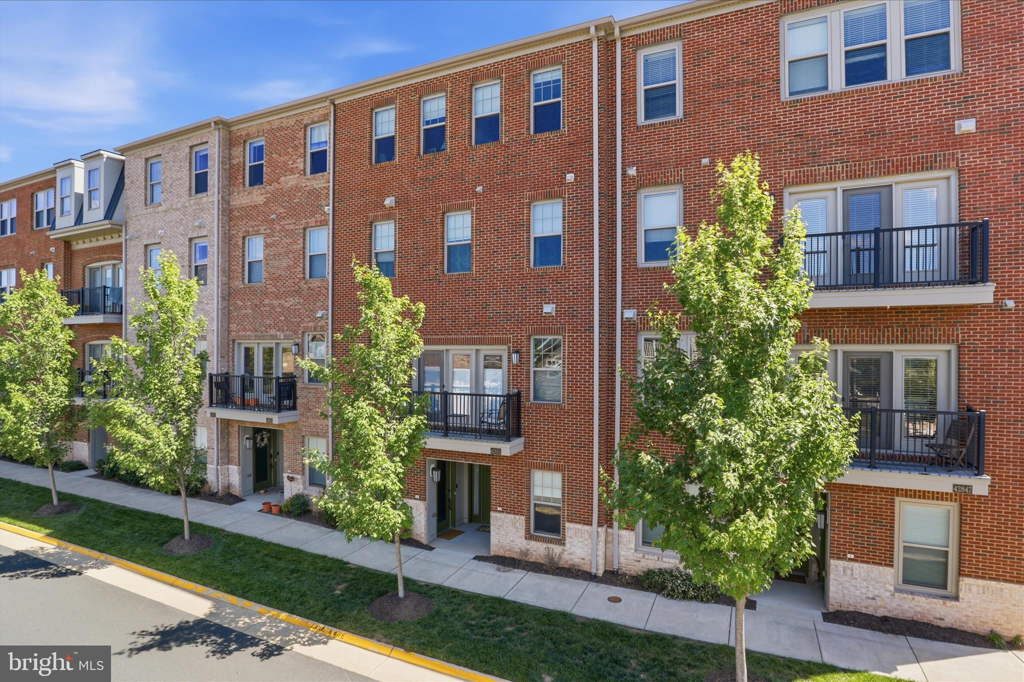 Experience the best of active adult living in Birchwood at Brambleton, Loudoun County's premier 55+ community. This beautifully appointed four-level townhome-style condominium offers nearly 2,500 square feet of thoughtfully designed living space, featuring a private elevator that provides effortless access to every level. The bright, open main level is ideal for both everyday living and entertaining, showcasing 9-foot ceilings, stylish LVP flooring, and a gourmet white kitchen with granite countertops, stainless steel appliances, a spacious walk-in pantry, and a large center island. Step outside to your private balcony, perfect for morning coffee or relaxing evenings. A true retreat, the entire third level is dedicated to the expansive primary suite, complete with a spa-inspired bath featuring dual vanities, a soaking tub, oversized shower, convenient laundry area, and generous storage. The upper level offers two additional bedrooms and a full bath, providing comfortable accommodations for visiting family and guests. On the entry level, you'll find a welcoming living area, perfect for relaxing, or a private office or entertaining friends/family on game nights, and also includes a private attached 1 car garage.  Just steps from your front door, enjoy Birchwood's exceptional resort-style amenities, including indoor and outdoor pools, a state-of-the-art fitness center, clubhouse, theater room, golf simulator, pickleball and bocce courts, scenic walking trails along the water, a fishing pier, community garden, and an active social calendar designed to foster connection and community.The HOA fee includes Verizon Fios cable and internet, adding even more value and convenience. Ideally located near Brambleton Town Center, shopping, dining, healthcare services, the Silver Line Metro, and Dulles International Airport, this exceptional home offers the perfect blend of comfort, convenience, and vibrant community living.